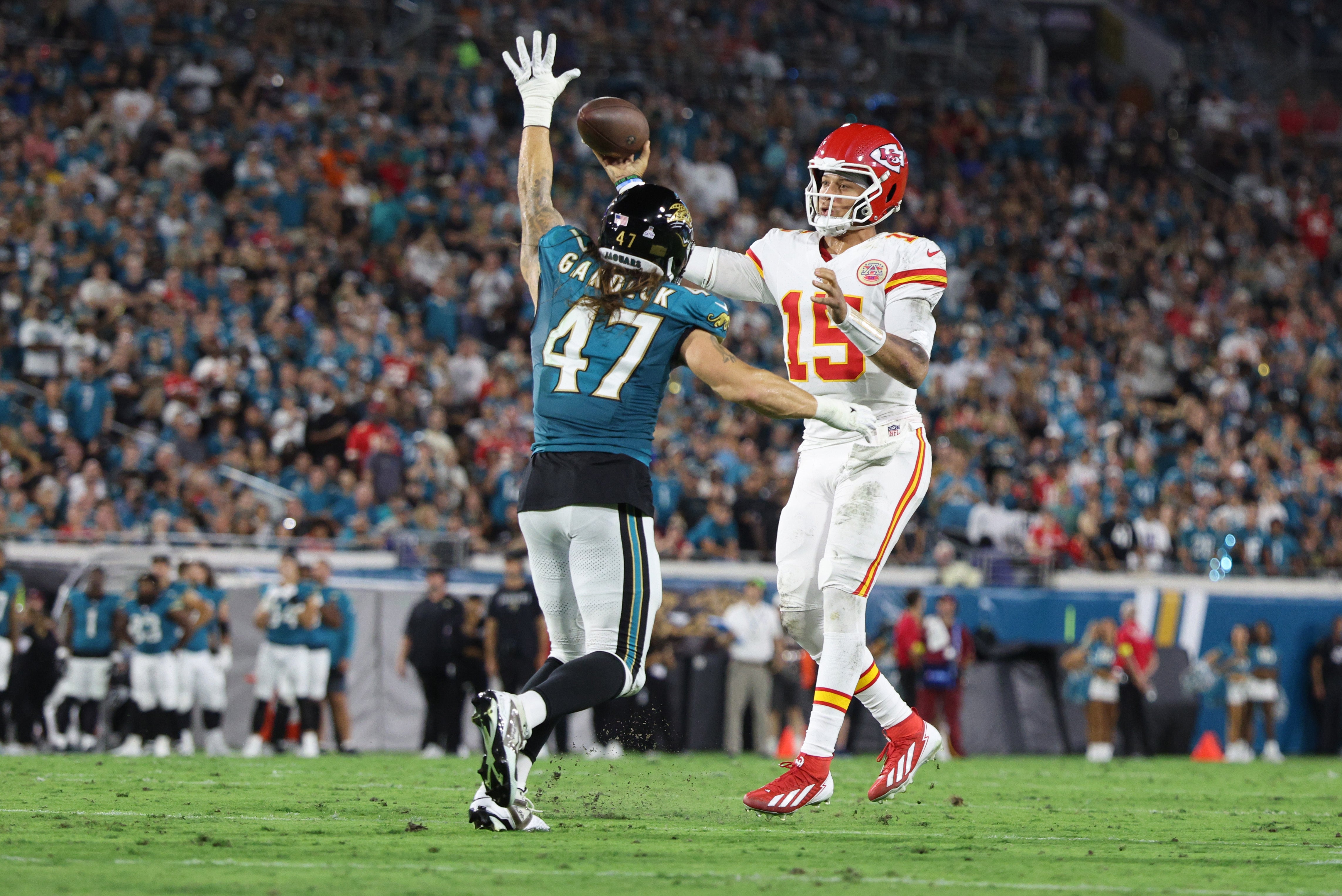 Kansas City Chiefs quarterback Patrick Mahomes (15) throws against Jacksonville Jaguars linebacker Dennis Gardeck (47)