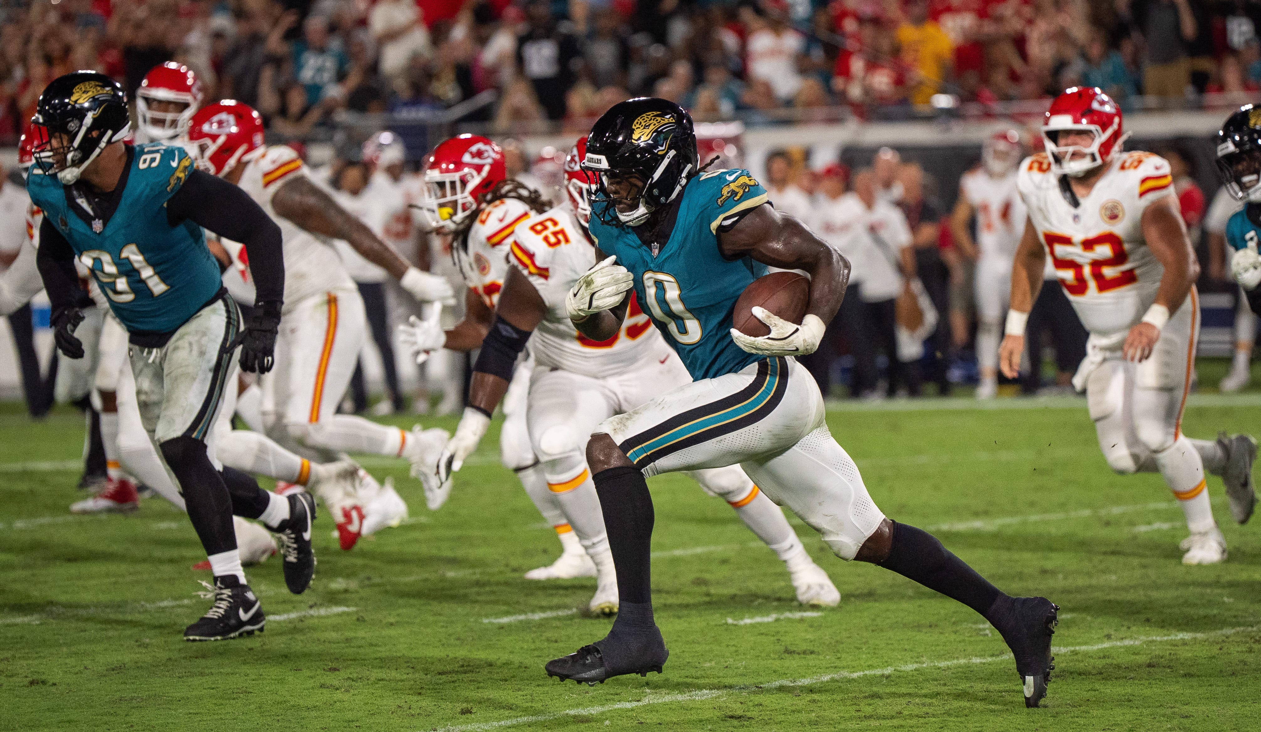 Jacksonville Jaguars linebacker Devin Lloyd (0) runs back an interception for a pick six in the third quarter during a Monday Night NFL football game at EverBank Stadium, Monday, Oct. 6, 2025, in Jacksonville, Fla.