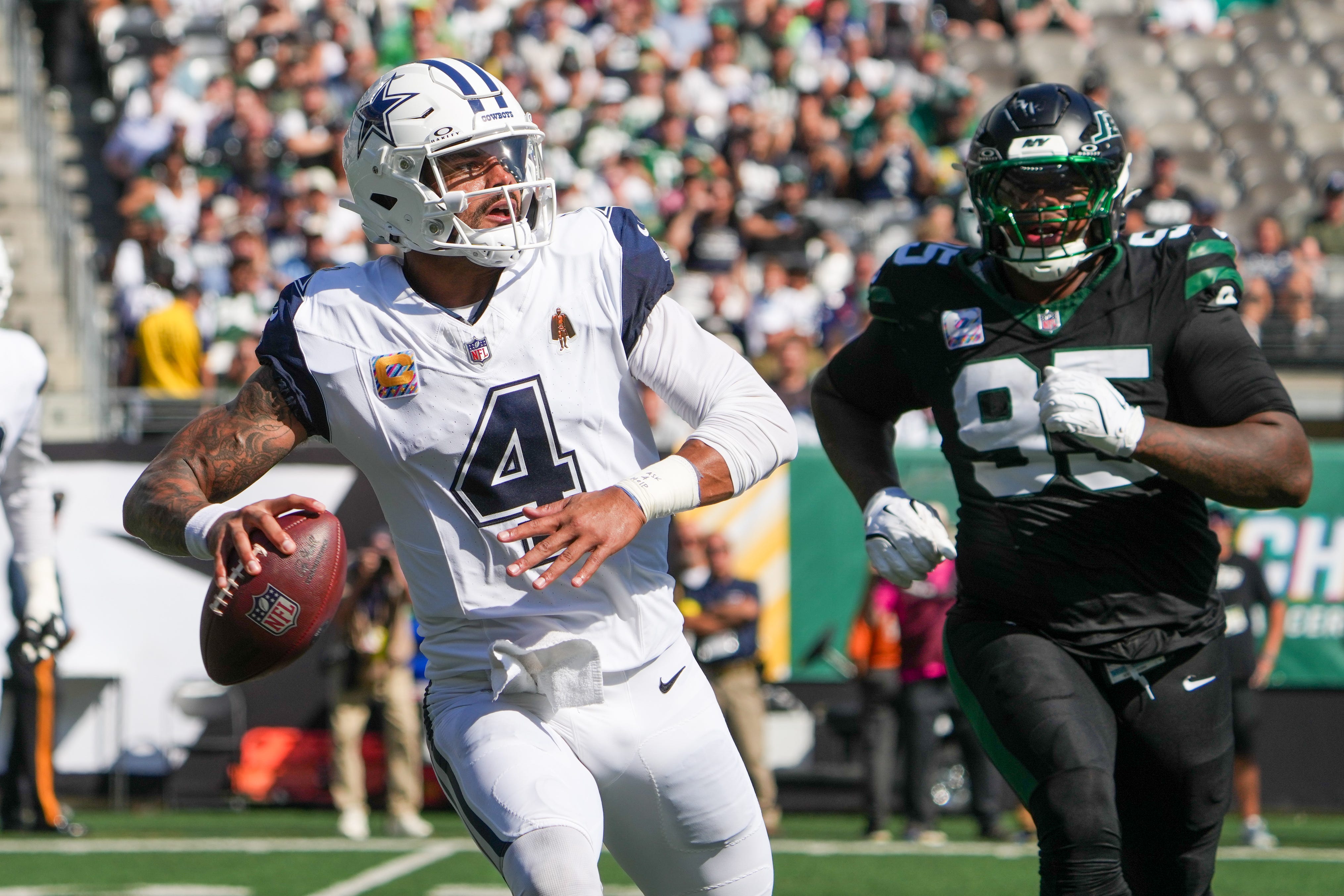 Oct 5, 2025; East Rutherford, New Jersey, USA; Dallas Cowboys quarterback Dak Prescott (4) looks to pass downfield as New York Jets defensive tackle Quinnen Williams (95) defends during the first half at MetLife Stadium.