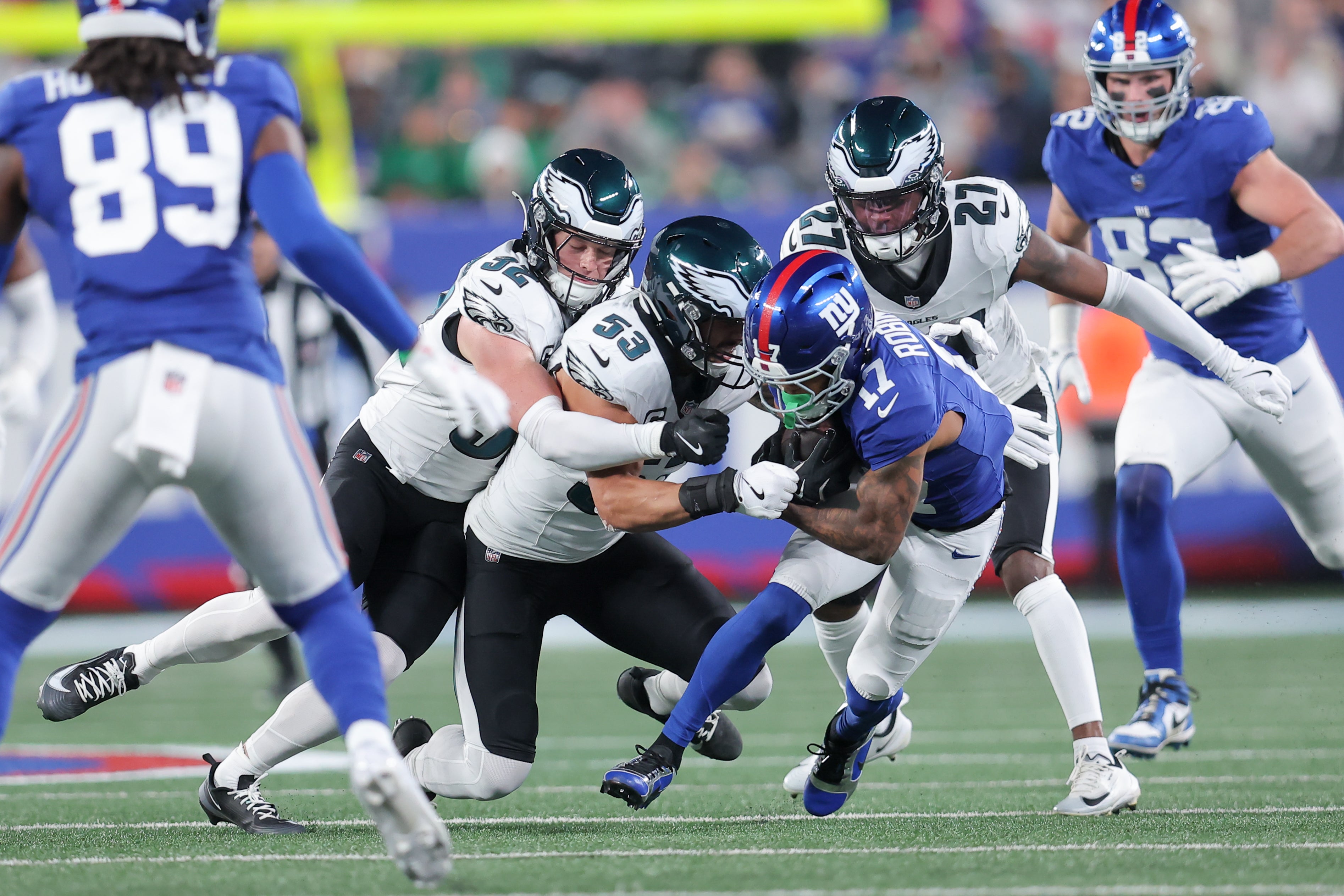 New York Giants wide receiver Wan'Dale Robinson (17) carries the ball defended by Philadelphia Eagles safety Reed Blankenship (32), linebacker Zack Baun (53) and cornerback Quinyon Mitchell (27)