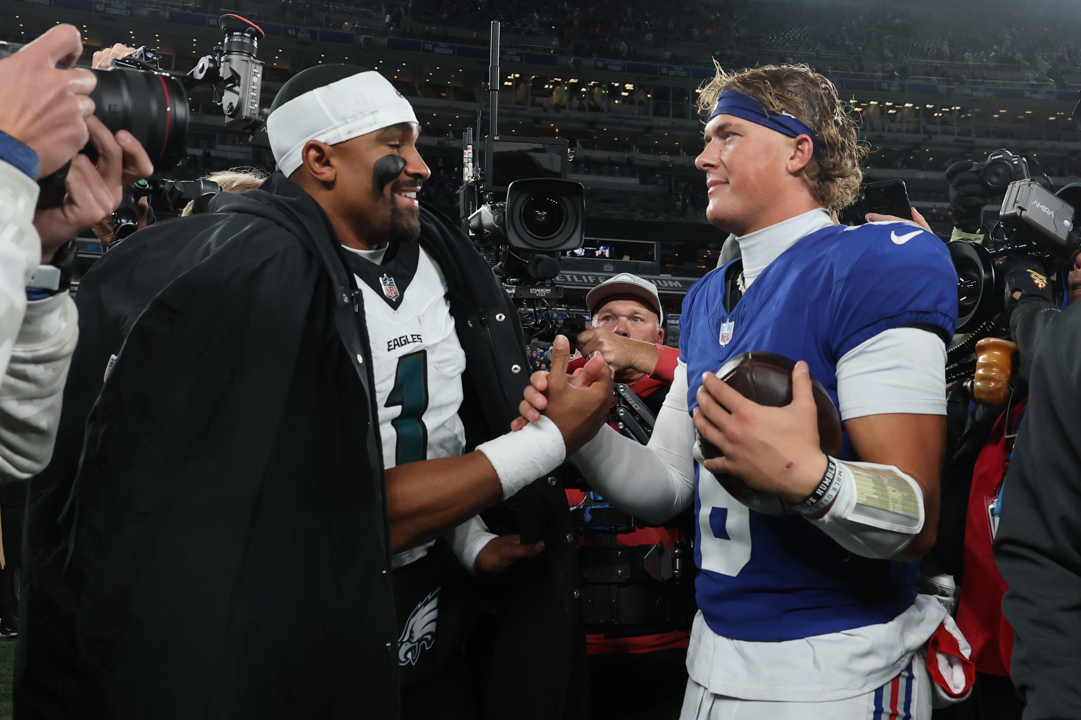 Philadelphia Eagles quarterback Jalen Hurts (1) and New York Giants quarterback Jaxson Dart (6) shake hands after the game at MetLife Stadium.