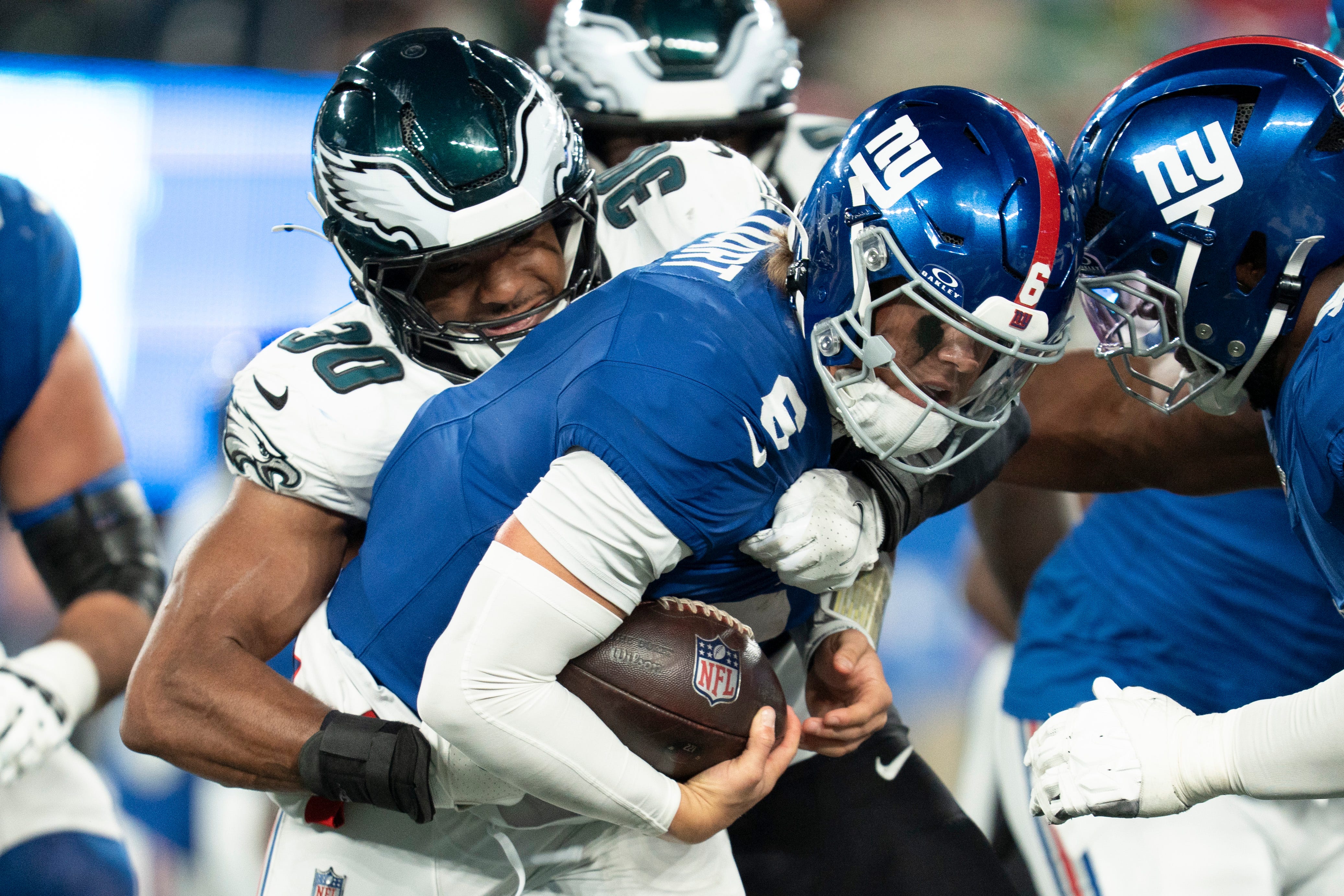 New York Giants quarterback Jaxson Dart (6) is tackled by Philadelphia Eagles linebacker Jihaad Campbell (30) during a Thursday Night Football game between the New York Giants and the Philadelphia Eagles at MetLife Stadium in East Rutherford on Oct. 9, 2025.