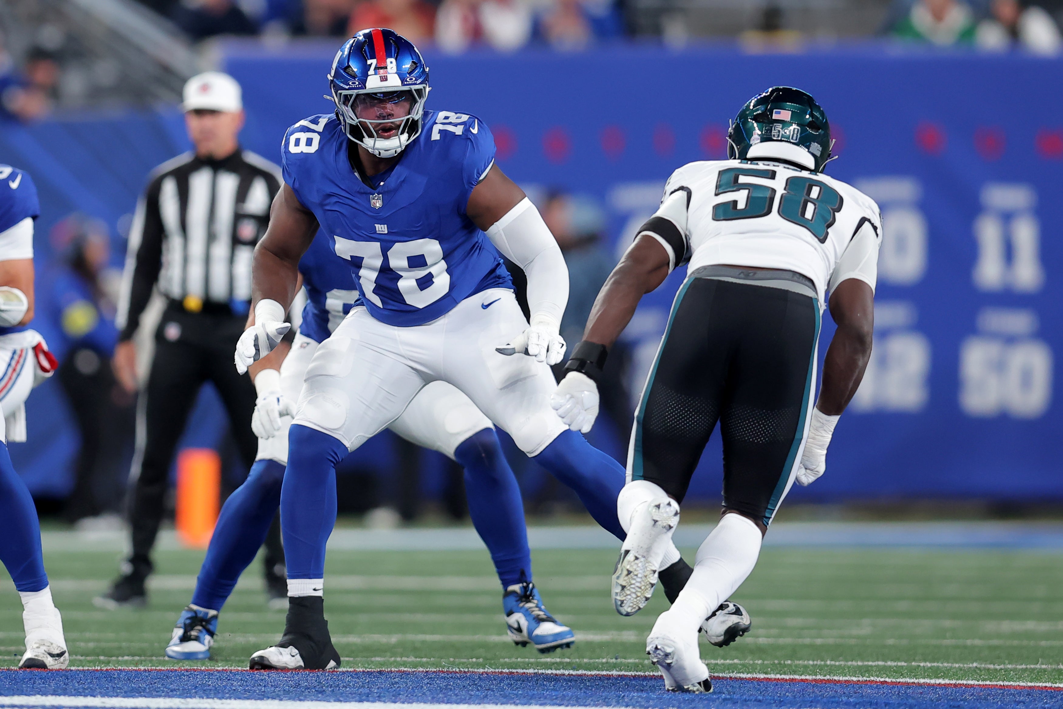 Oct 9, 2025; East Rutherford, New Jersey, USA; New York Giants offensive tackle Andrew Thomas (78) blocks against Philadelphia Eagles linebacker Jalyx Hunt (58) during the first quarter at MetLife Stadium.
