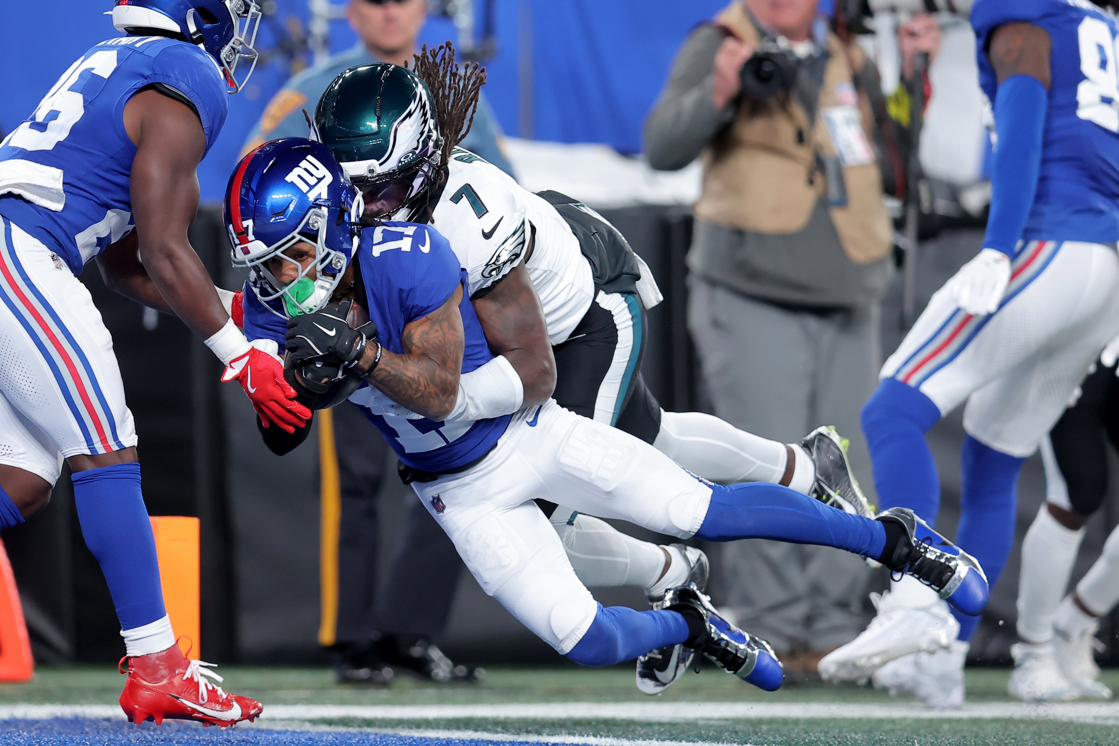 New York Giants wide receiver Wan'Dale Robinson (17) dives for a touchdown against Philadelphia Eagles cornerback Kelee Ringo (7) during the first quarter at MetLife Stadium.