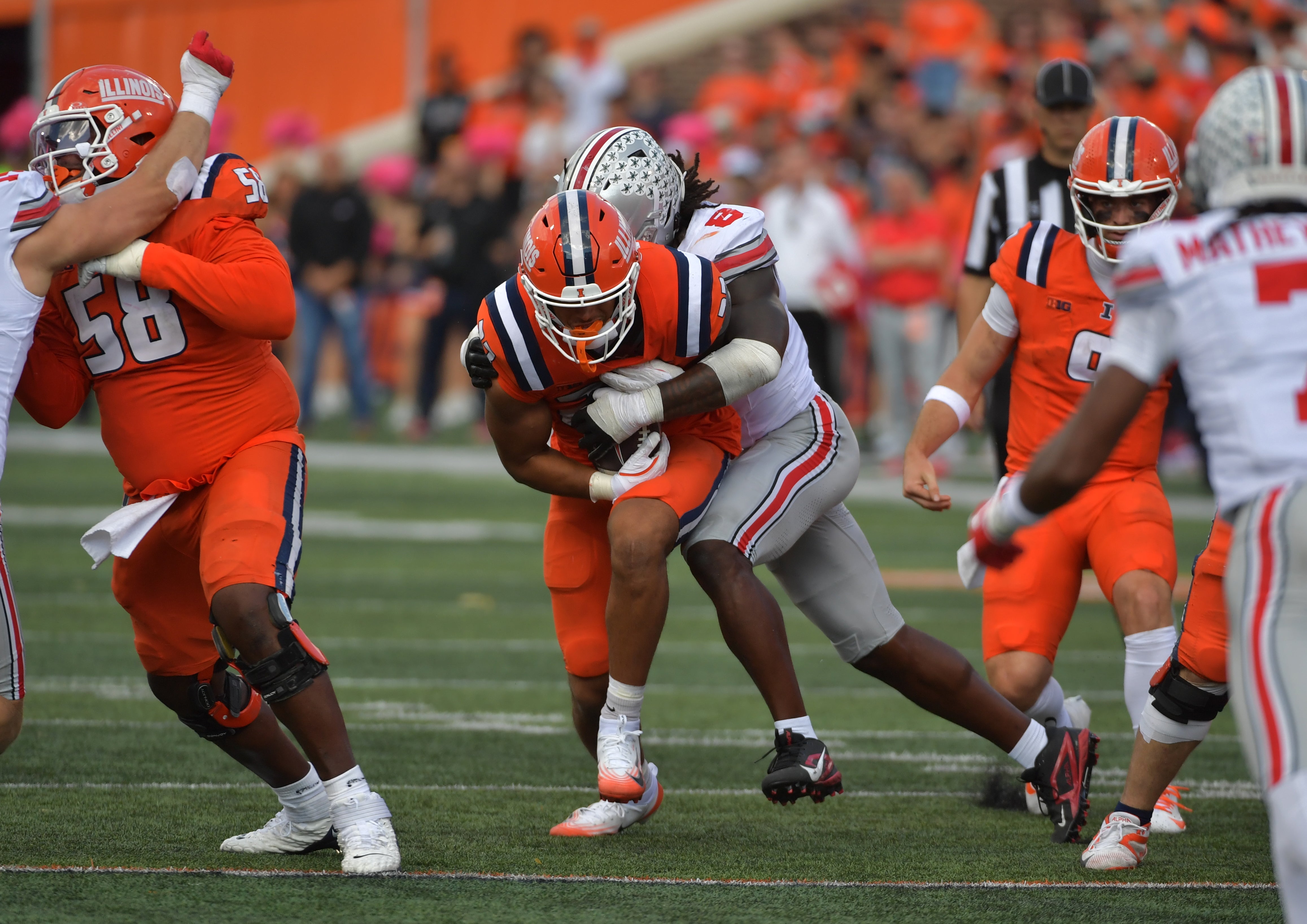 Oct 11, 2025; Champaign, Illinois, USA; Illinois Fighting Illini tight end Jordan Anderson (23) is tackled by Ohio State Buckeyes linebacker Arvell Reese (8) during the second half at Memorial Stadium. Mandatory Credit: Ron Johnson-Imagn Images
