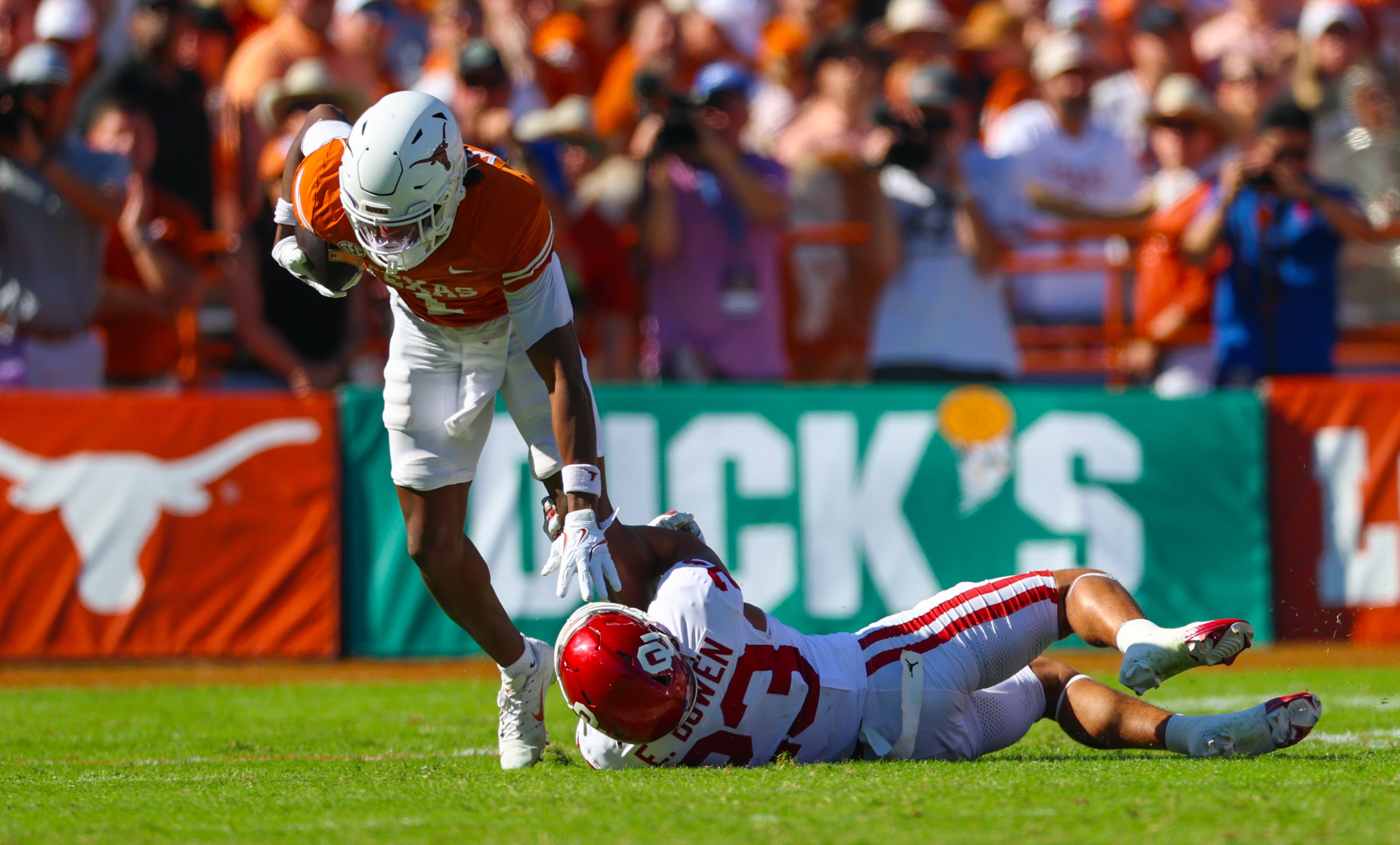 Oct 11, 2025; Dallas, Texas, USA; Oklahoma Sooners defensive back Eli Bowen (23) tackles Texas Longhorns wide receiver Ryan Wingo (1) during the first half at the Cotton Bowl. Mandatory Credit: Kevin Jairaj-Imagn Images