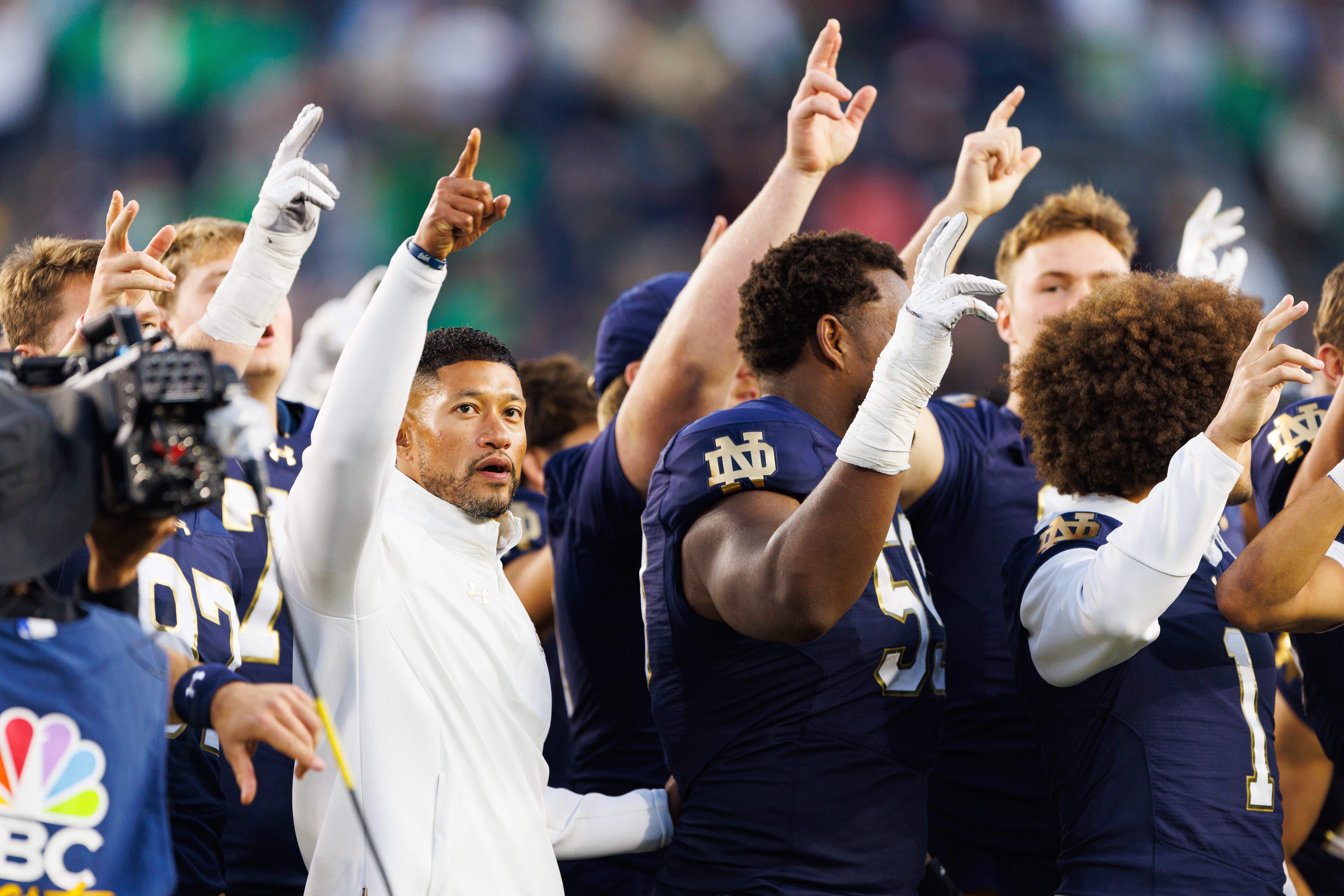 Notre Dame head coach Marcus Freeman celebrates with his players after winning a NCAA football game 36-7 against NC State at Notre Dame Stadium on Saturday, Oct. 11, 2025, in South Bend.