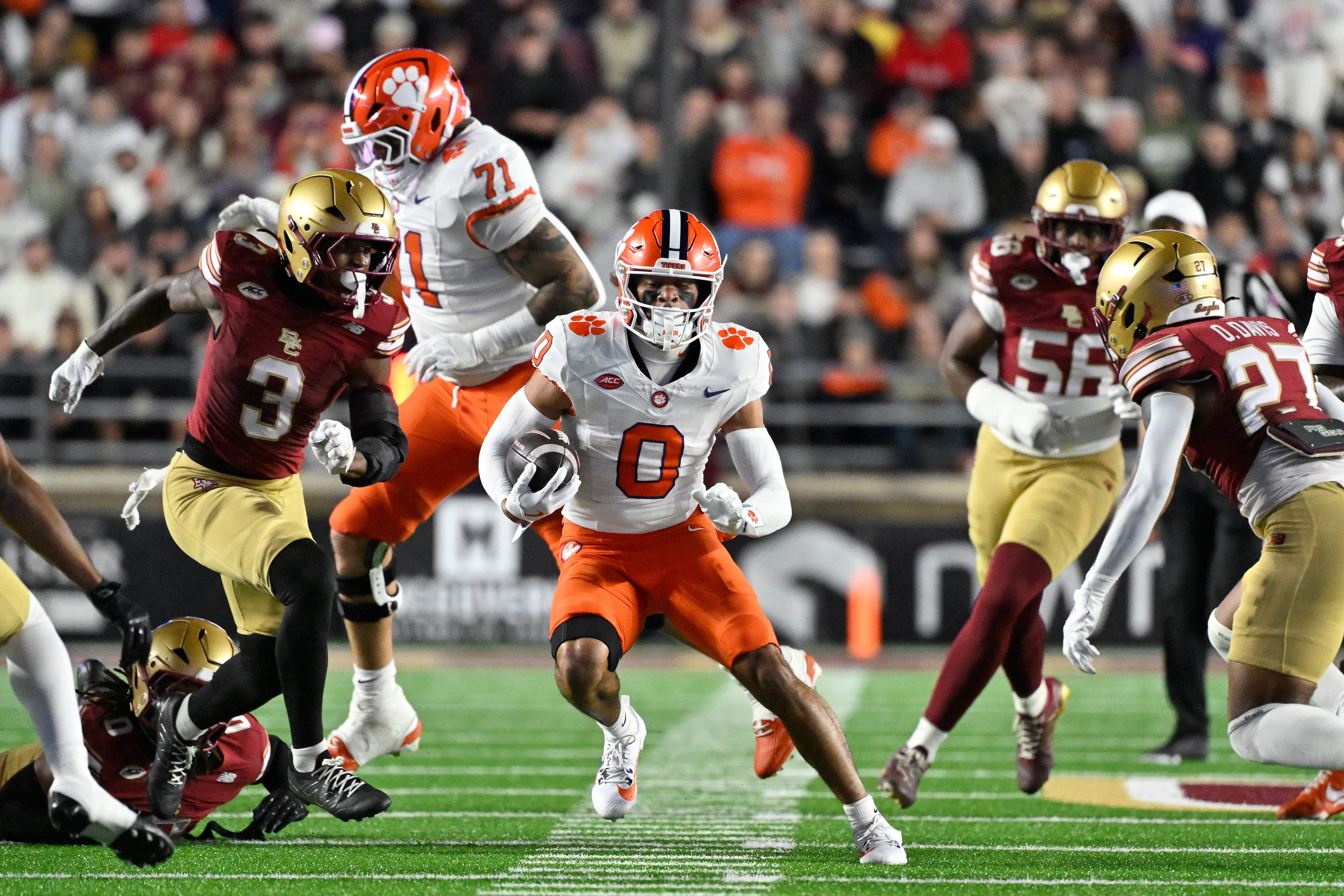 Oct 11, 2025; Chestnut Hill, Massachusetts, USA; Clemson Tigers wide receiver Antonio Williams (0) runs the ball with Boston College Eagles defensive back Max Tucker (3) giving chase during the first half at Alumni Stadium. Mandatory Credit: Eric Canha-Imagn Images