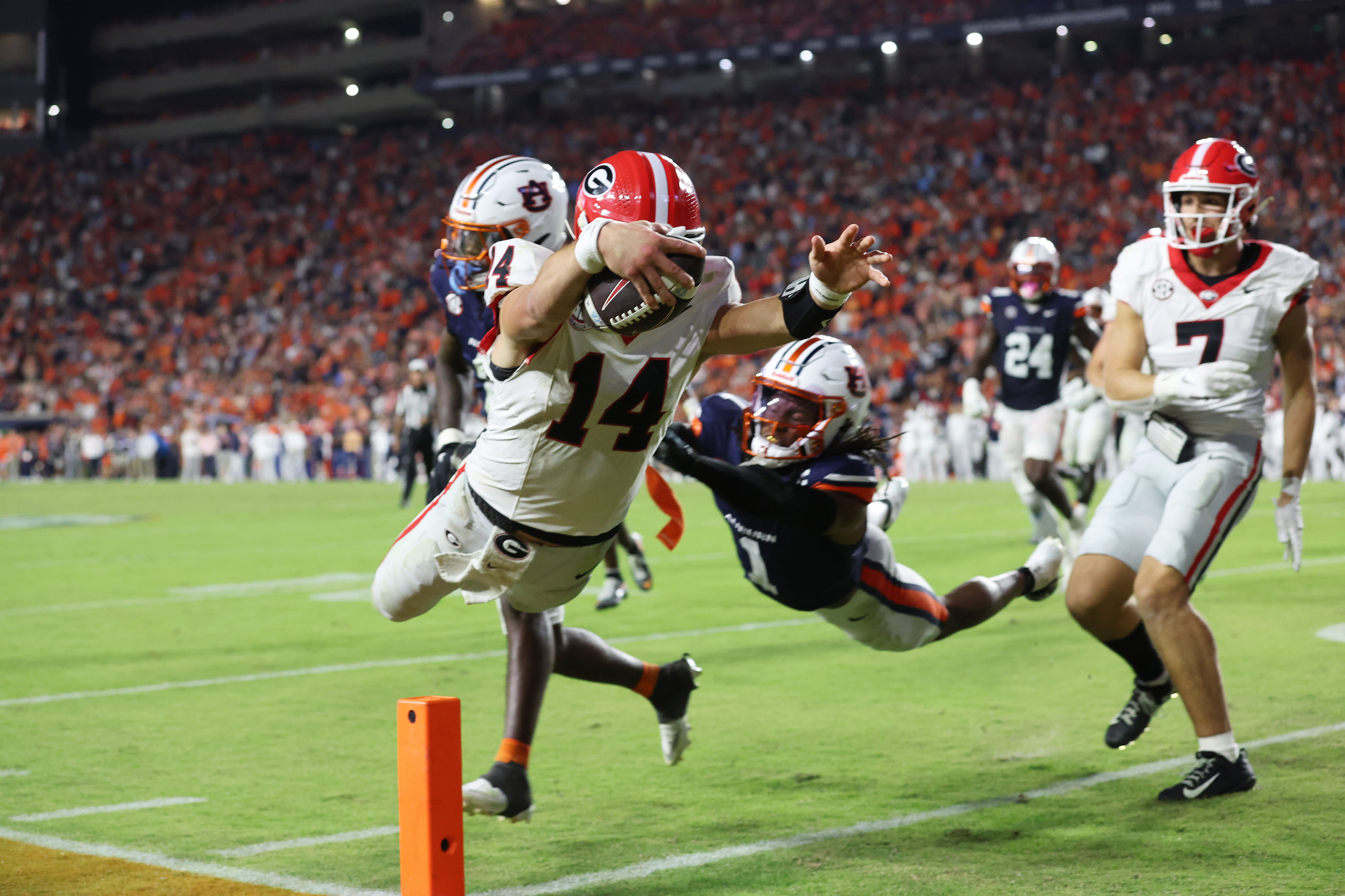 Georgia Bulldogs quarterback Gunner Stockton (14) dives for the end zone and scores during the fourth quarter against the Auburn Tigers at Jordan-Hare Stadium.