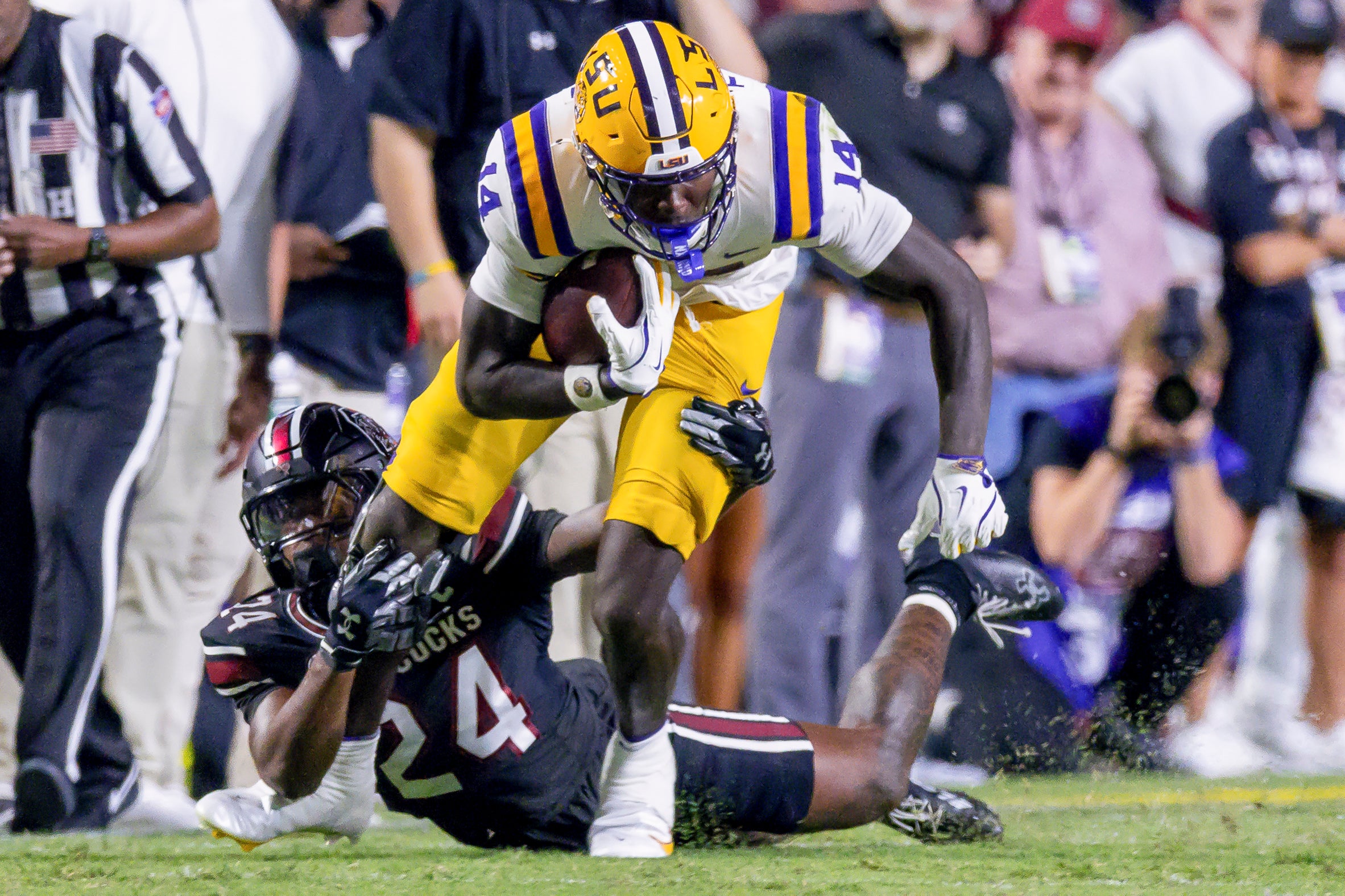 Oct 11, 2025; Baton Rouge, Louisiana, USA; South Carolina Gamecocks defensive back Jalon Kilgore (24) tackles LSU Tigers tight end Trey'Dez Green (14) during the second half at Tiger Stadium. Mandatory Credit: Stephen Lew-Imagn Images