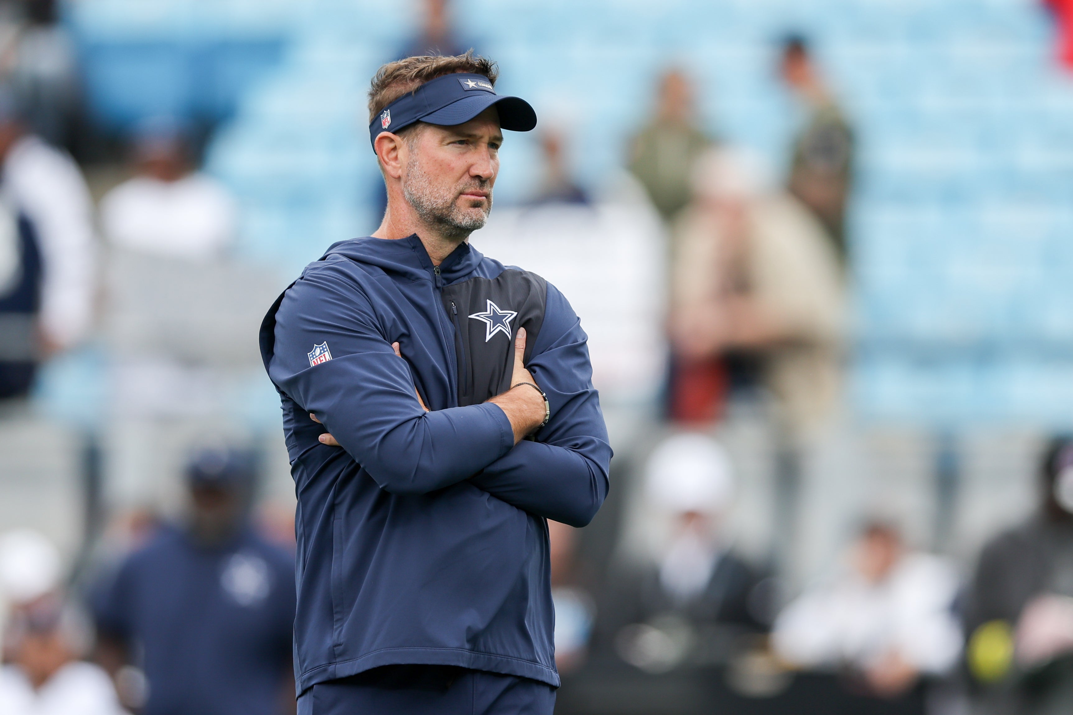 Oct 12, 2025; Charlotte, North Carolina, USA; Dallas Cowboys head coach Brian Schottenheimer looks on during warm ups prior the game against the Carolina Panthers at Bank of America Stadium.