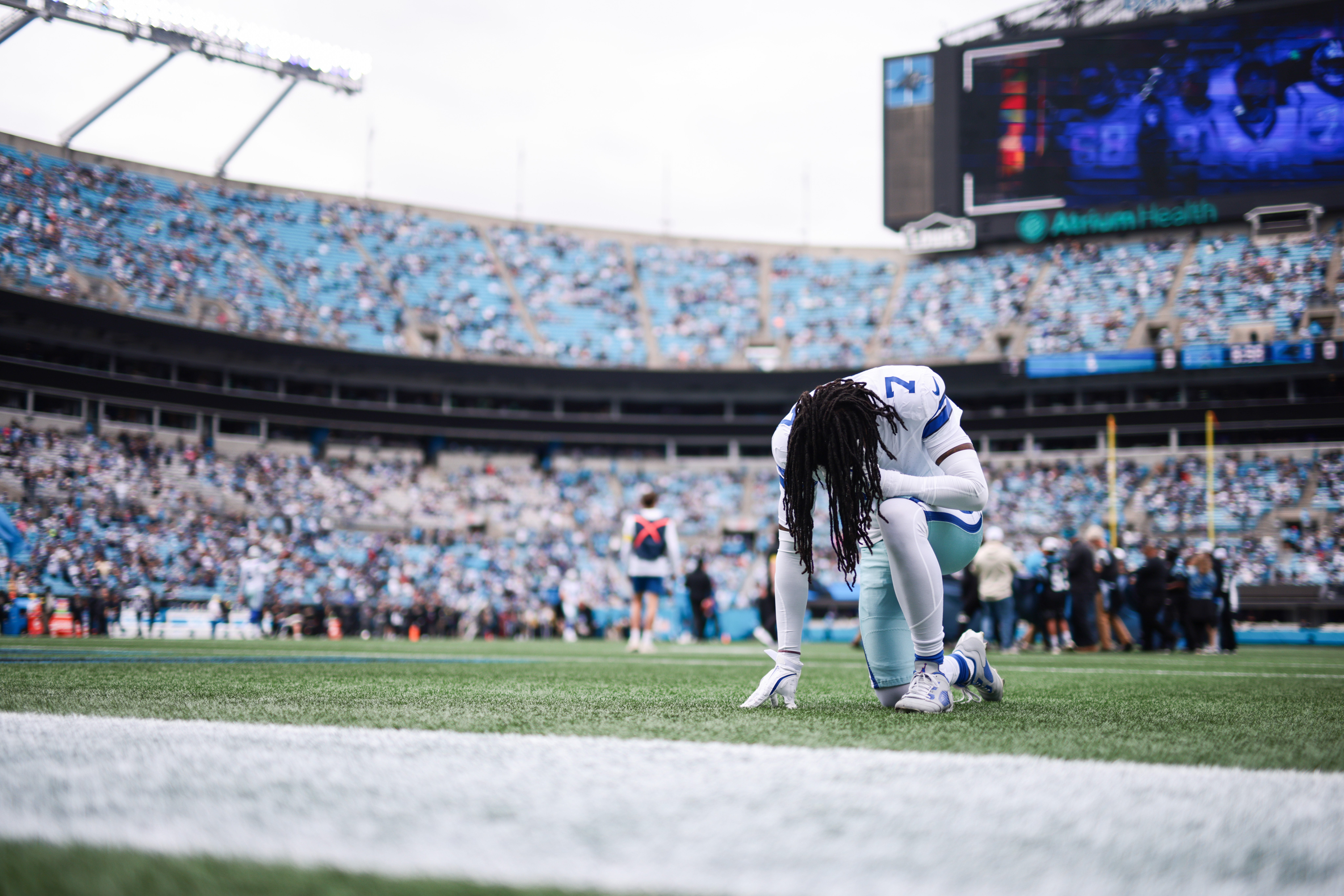 Oct 12, 2025; Charlotte, North Carolina, USA; Dallas Cowboys cornerback Trevon Diggs (7) kneels before the start of the game against the Carolina Panthers at Bank of America Stadium.