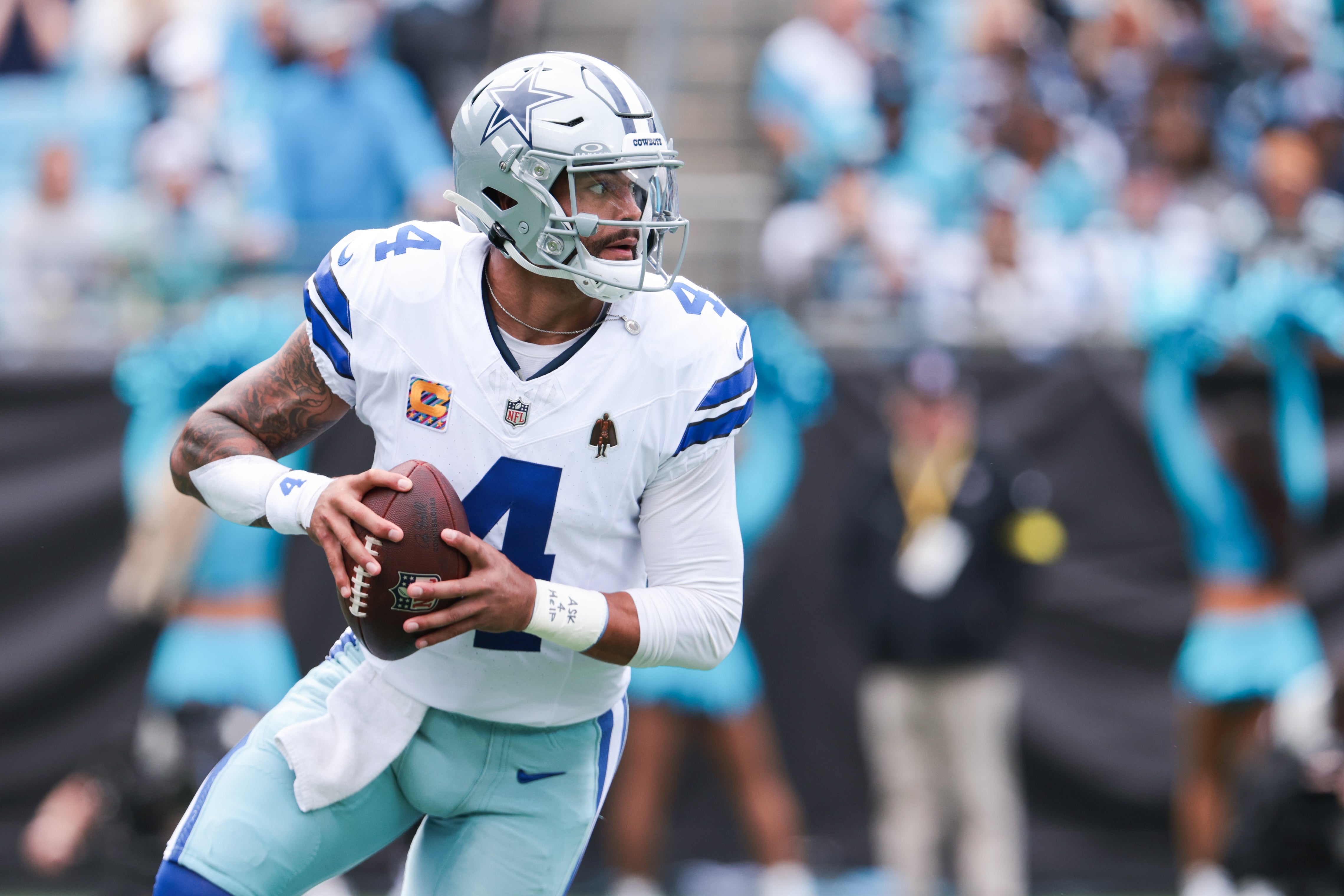 Dallas Cowboys quarterback Dak Prescott (4) looks for an open receiver during the first quarter against the Carolina Panthers at Bank of America Stadium.
