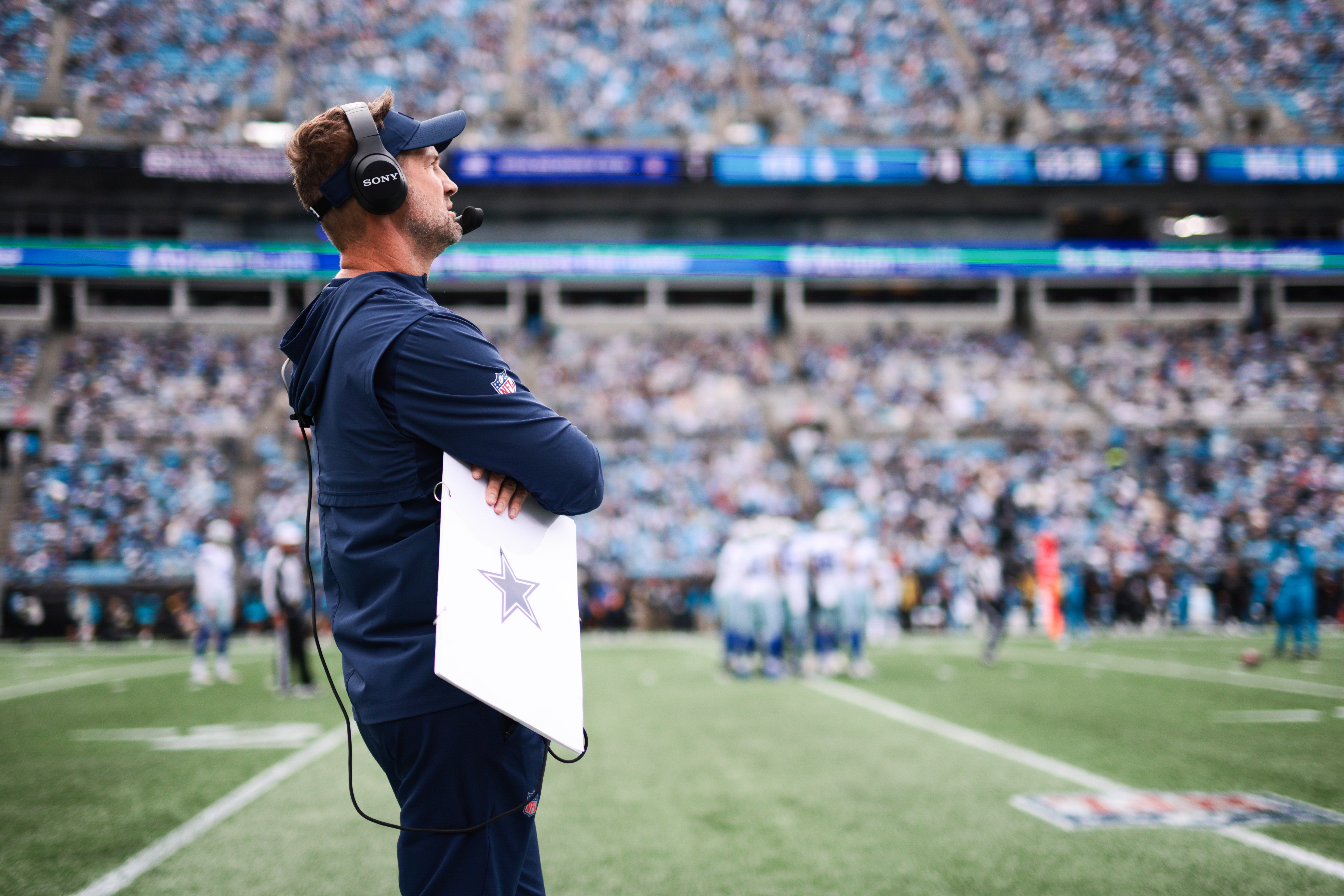 Oct 12, 2025; Charlotte, North Carolina, USA; Dallas Cowboys head coach Brian Schottenheimer looks on from the sideline during the first quarter against the Carolina Panthers at Bank of America Stadium.