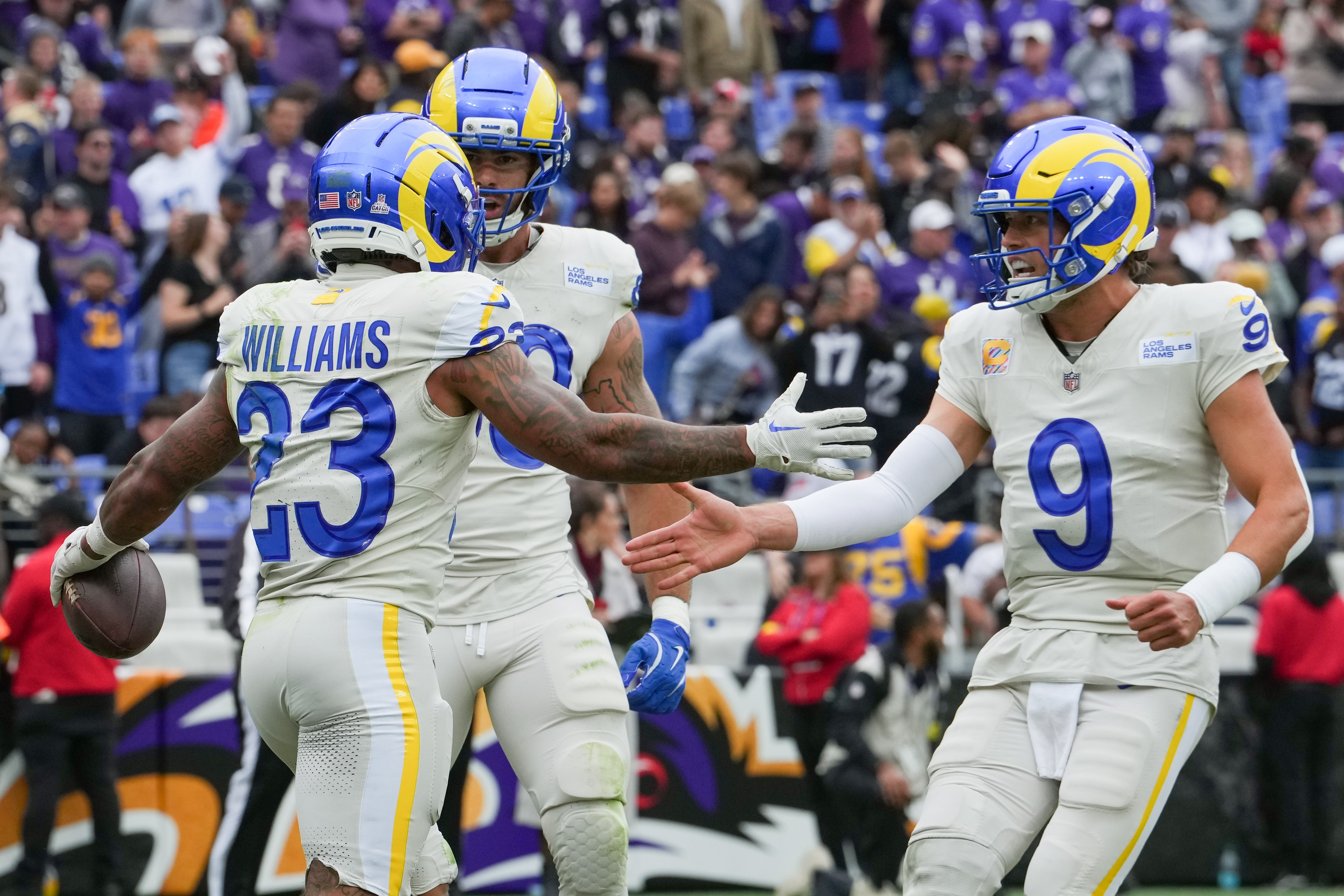 Oct 12, 2025; Baltimore, Maryland, USA; Los Angeles Rams running back Kyren Williams (23), tight end Tyler Higbee (89) and quarterback Matthew Stafford (9) celebrate after scoring a touchdown against the Baltimore Ravens during the third quarter of the game at M&T Bank Stadium.