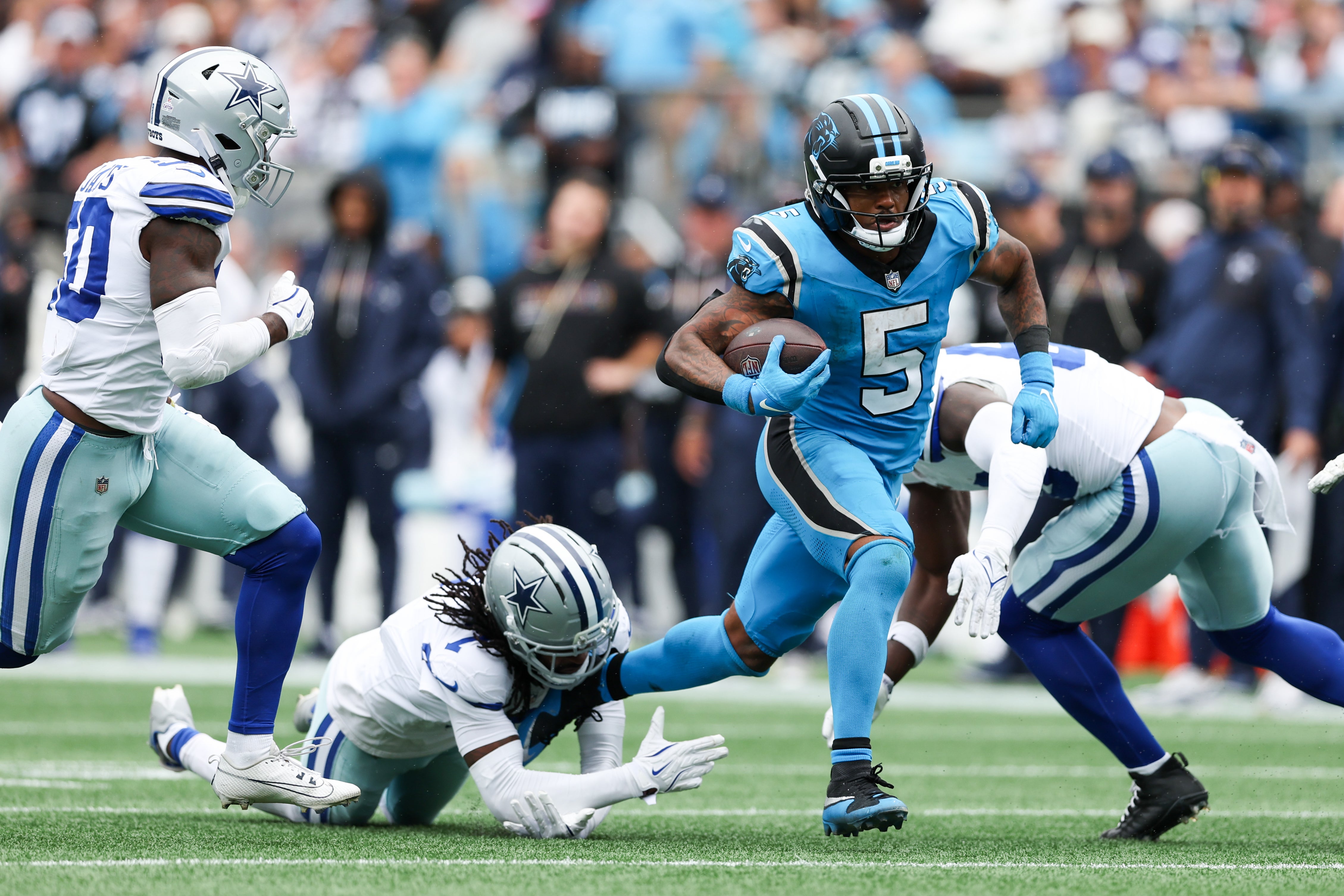 Oct 12, 2025; Charlotte, North Carolina, USA; Carolina Panthers running back Rico Dowdle (5) runs with the ball during the second half against the Dallas Cowboys at Bank of America Stadium.