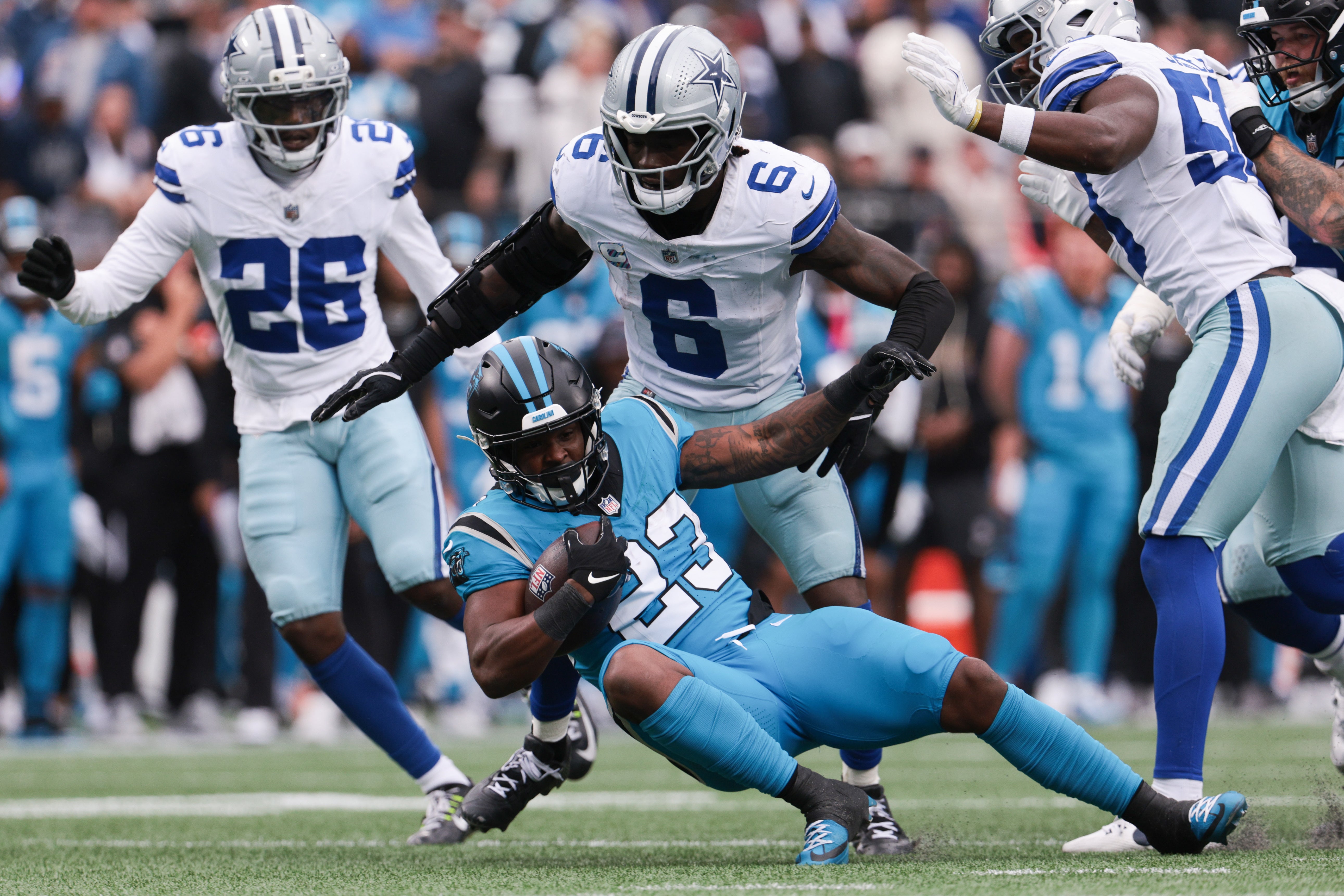 Oct 12, 2025; Charlotte, North Carolina, USA; Carolina Panthers running back Trevor Etienne (23) gets a first down during the second half against the Dallas Cowboys at Bank of America Stadium.