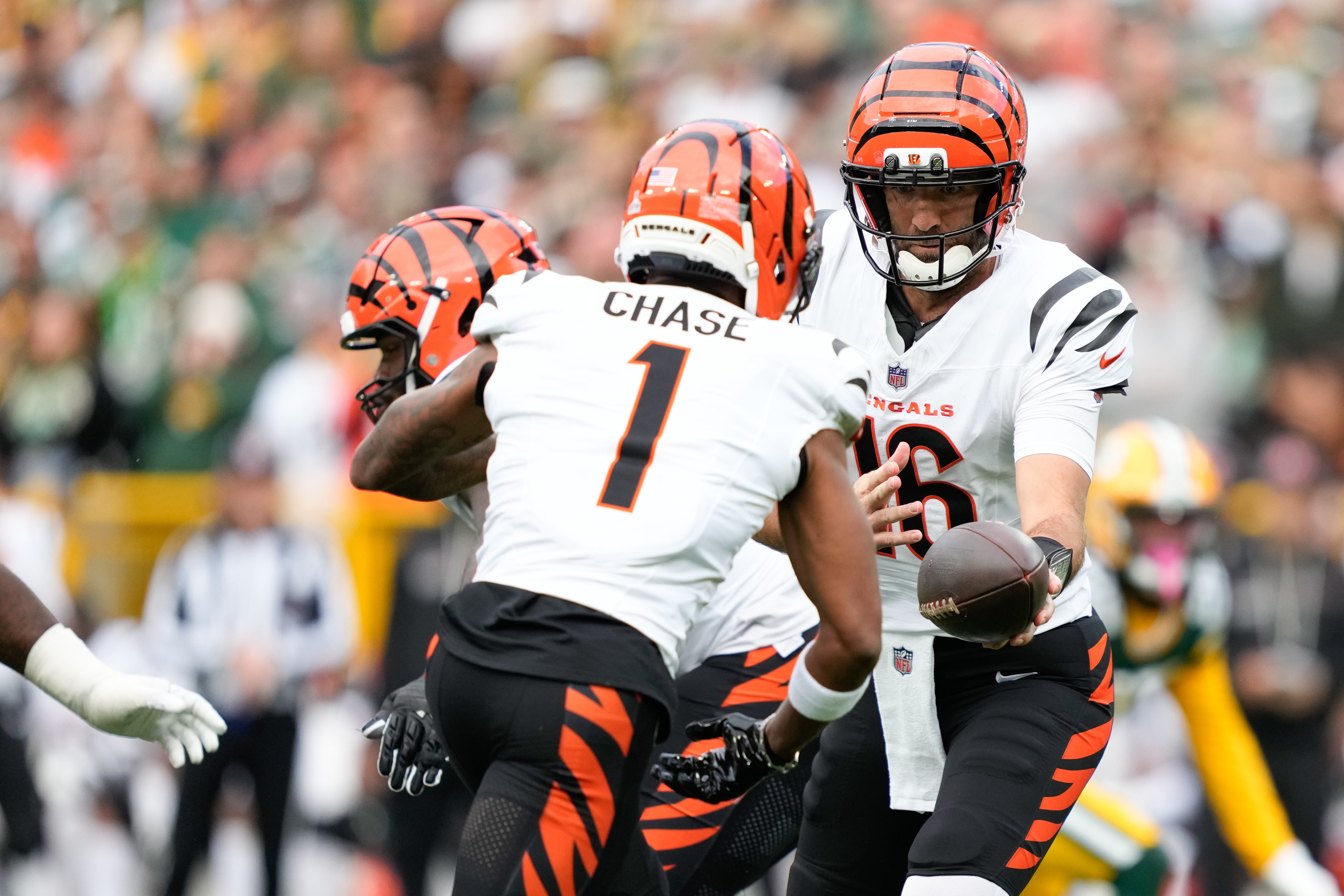 Oct 12, 2025; Green Bay, Wisconsin, USA; Cincinnati Bengals quarterback Joe Flacco (16) hands the ball off to wide receiver Ja'Marr Chase (1) in the first quarter against Green Bay Packers at Lambeau Field.