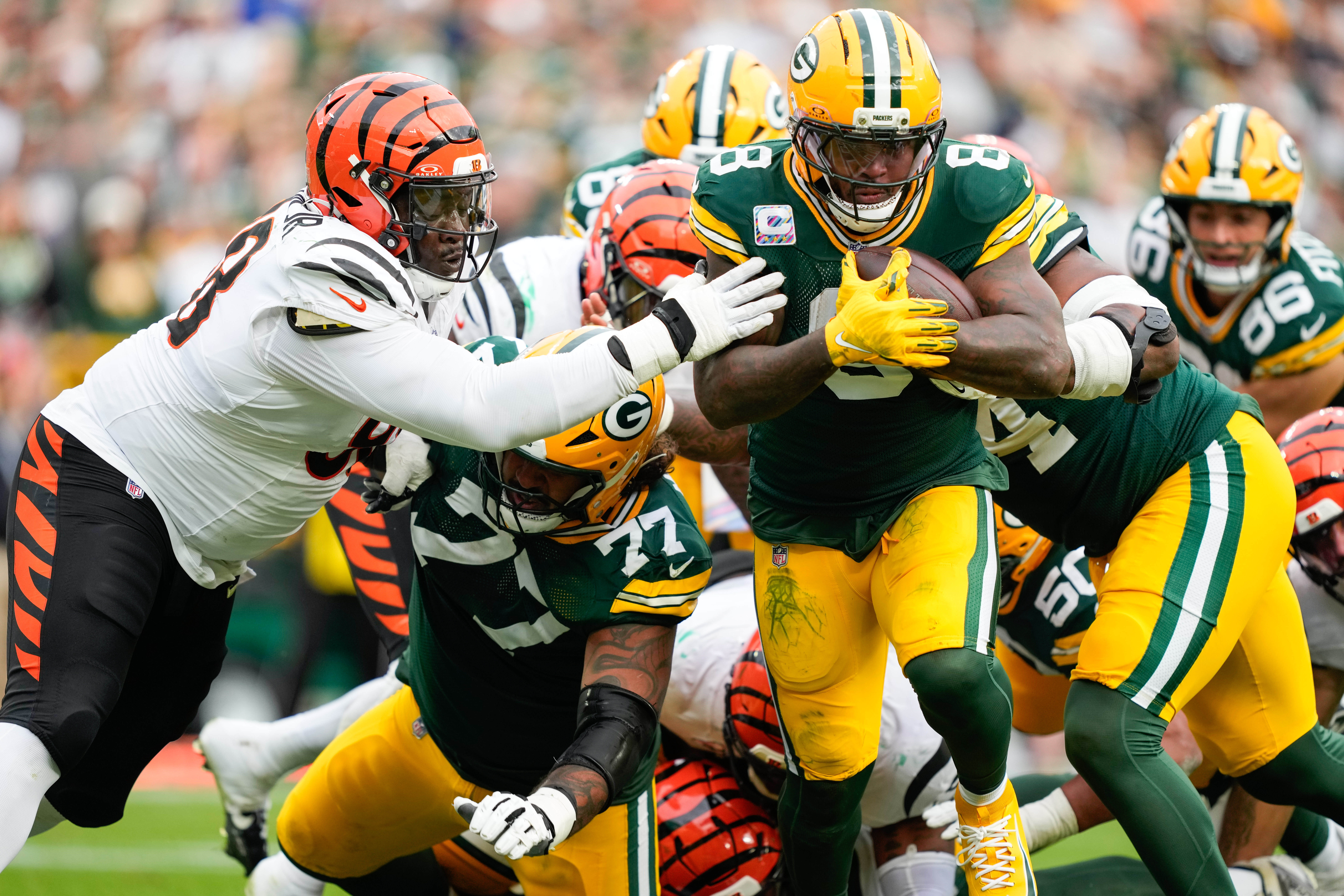 Oct 12, 2025; Green Bay, Wisconsin, USA; Green Bay Packers running back Josh Jacobs (8) scores a touchdown against the Cincinnati Bengals in the second quarter at Lambeau Field.