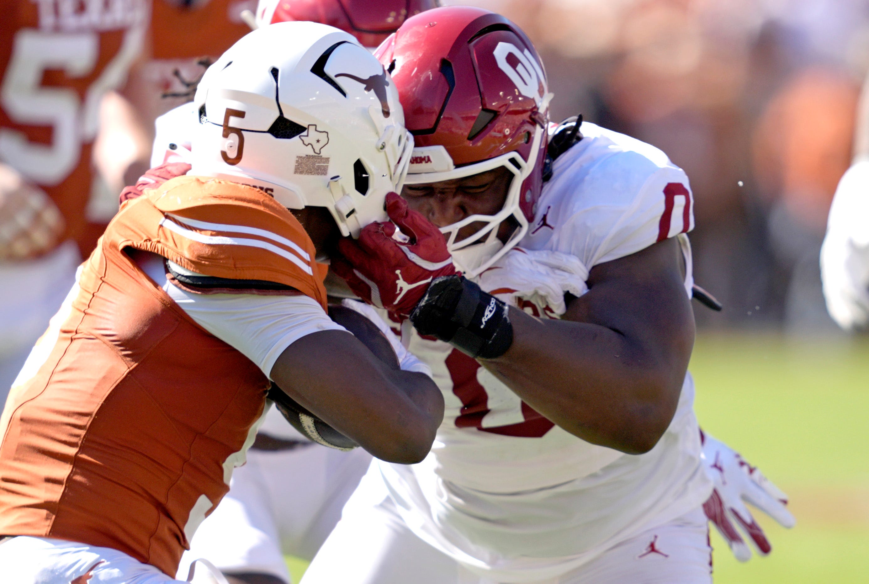 Oklahoma Sooners defensive lineman David Stone (0) tackles Texas Longhorns running back Quintrevion Wisner (5) in the first half of the Red River Rivalry college football game between the University of Oklahoma Sooners and the Texas Longhorn at the Cotton Bowl Stadium in Dallas, Texas, Saturday, Oct. 11, 2025.