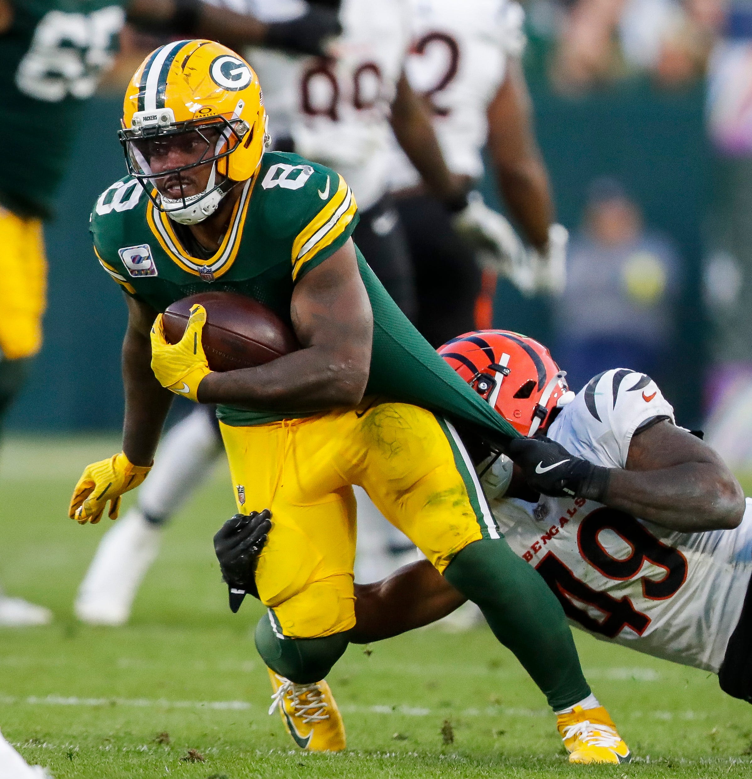 Green Bay Packers running back Josh Jacobs (8) is tackled by Cincinnati Bengals linebacker Barrett Carter (49) on Sunday, October 12, 2025, at Lambeau Field in Green Bay, Wis. The Packers won the game, 27-18.