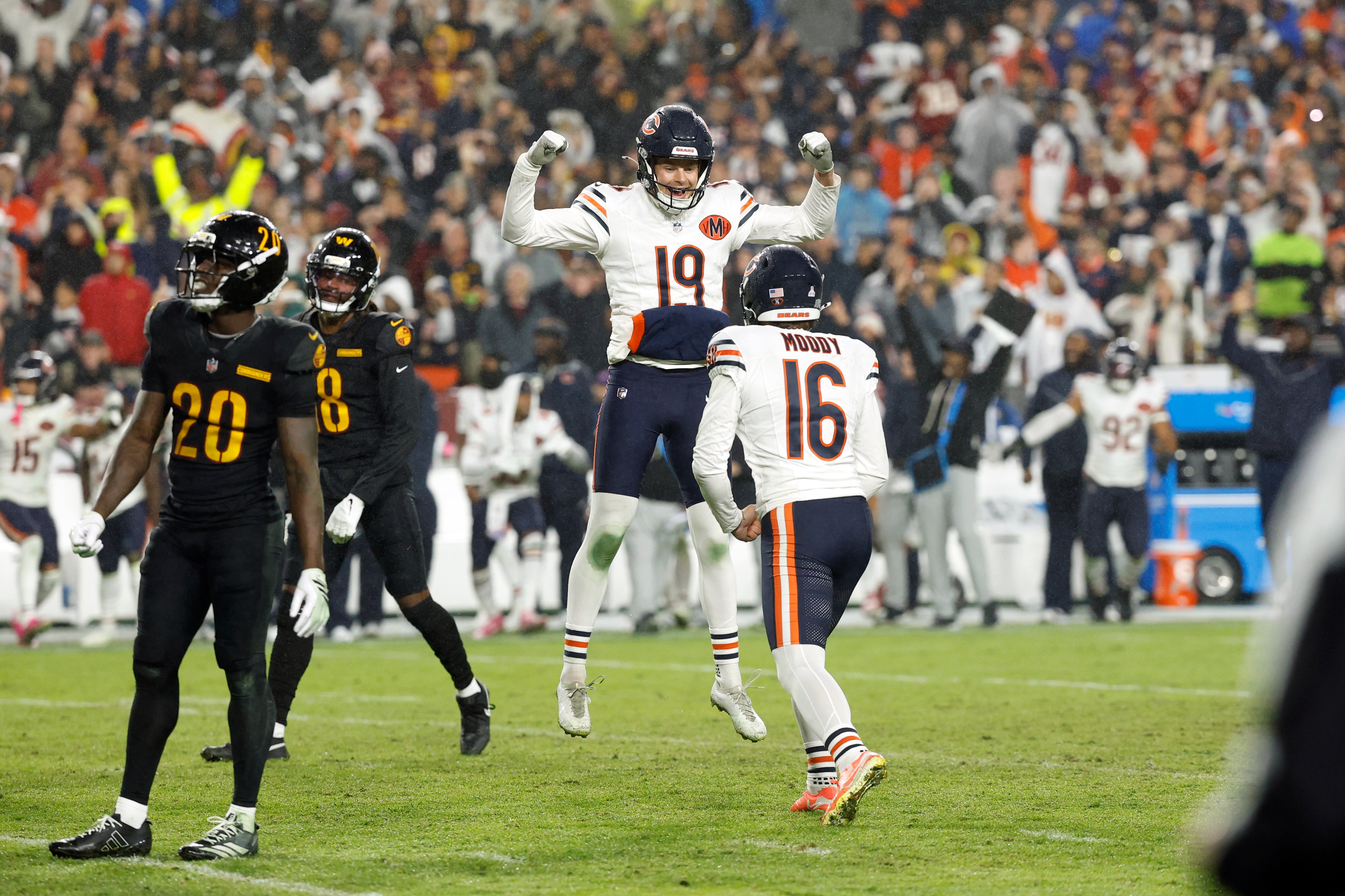 Oct 13, 2025; Landover, Maryland, USA; Chicago Bears kicker Jake Moody (16) celebrates with punter Tory Taylor (19) after kicking a game-winning field goal against the Washington Commanders during the fourth quarter at Northwest Stadium.