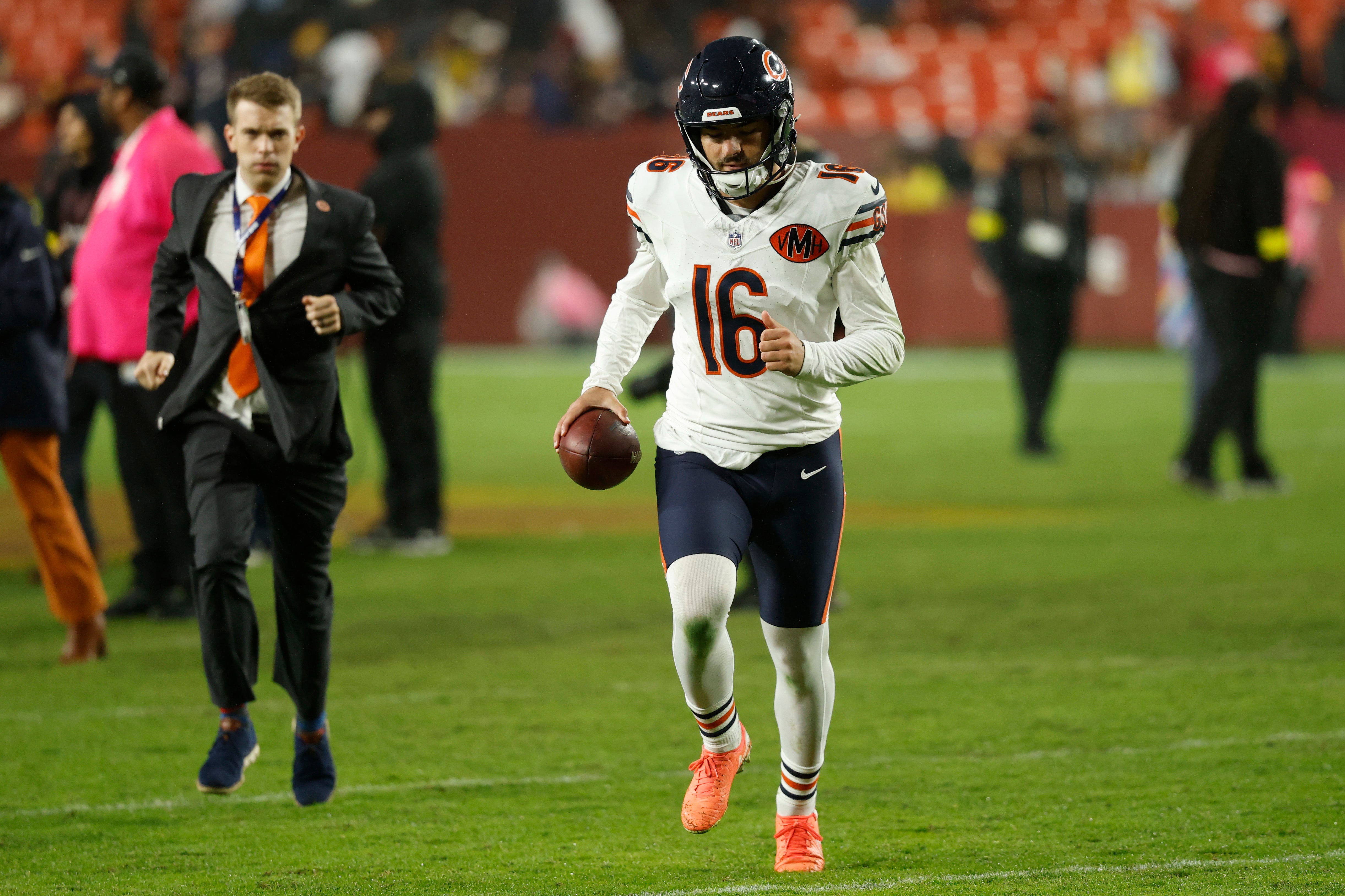 Oct 13, 2025; Landover, Maryland, USA; Chicago Bears kicker Jake Moody (16) runs off the field holding the game ball after making the game winning kick as time expired against the Washington Commanders at Northwest Stadium.