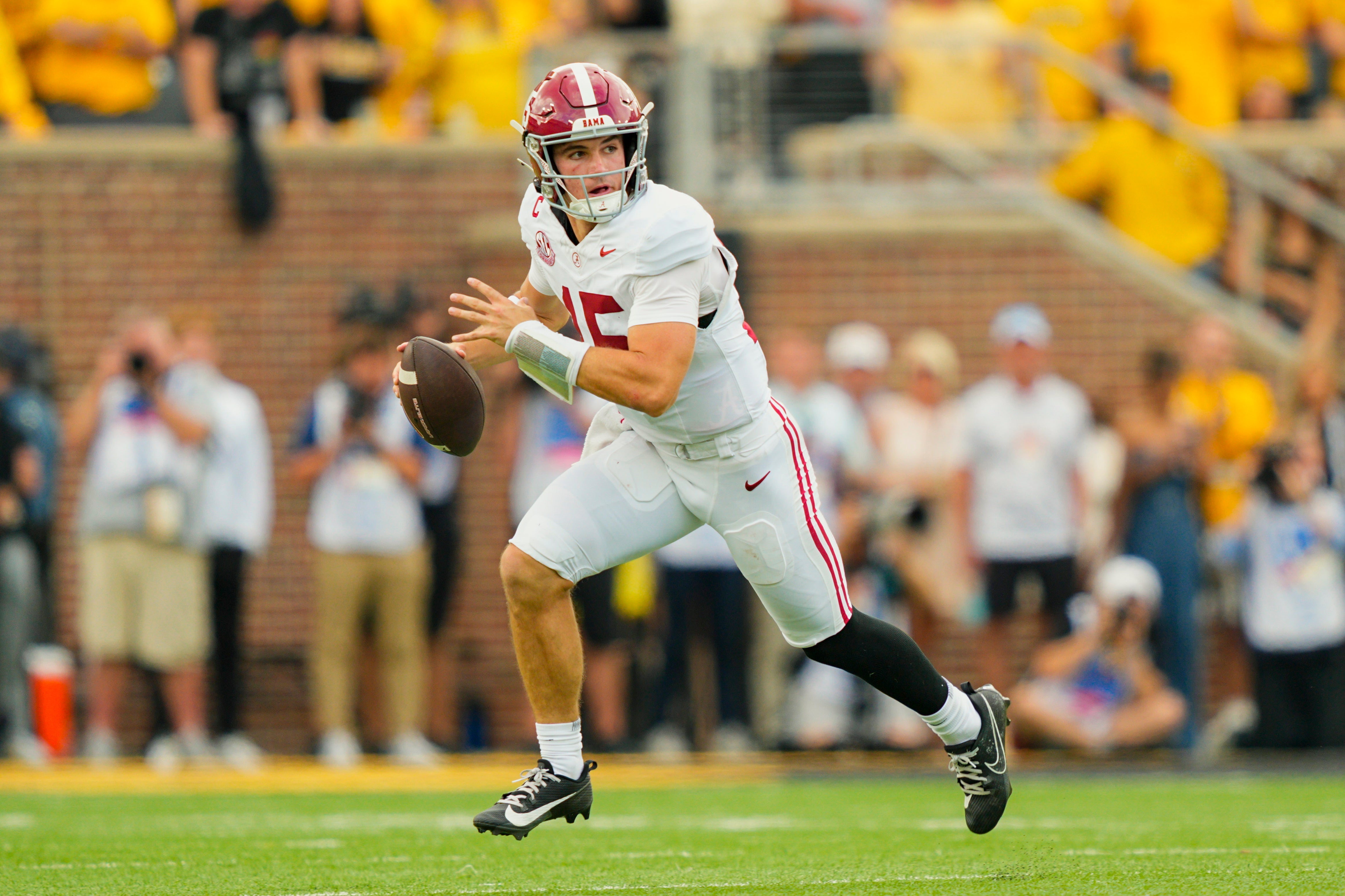 Oct 11, 2025; Columbia, Missouri, USA; Alabama Crimson Tide quarterback Ty Simpson (15) rolls out to pass during the second half against the Missouri Tigers at Faurot Field at Memorial Stadium.