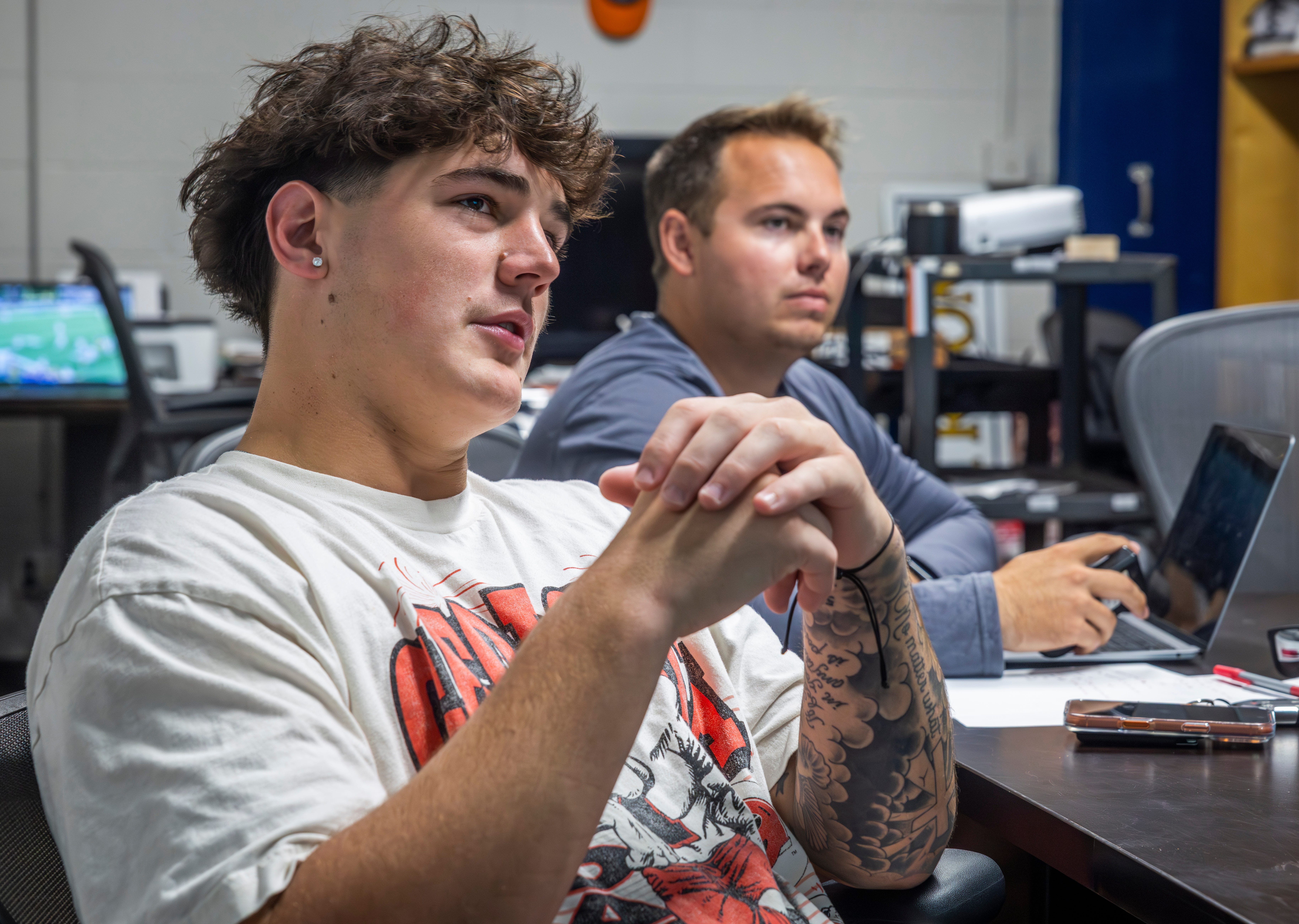 Nashville Christian quarterback Jared Curtis, left, reviews film with offensive coordinator Kyle Tidwell at the teams locker room Tuesday, Oct. 14, 2025.