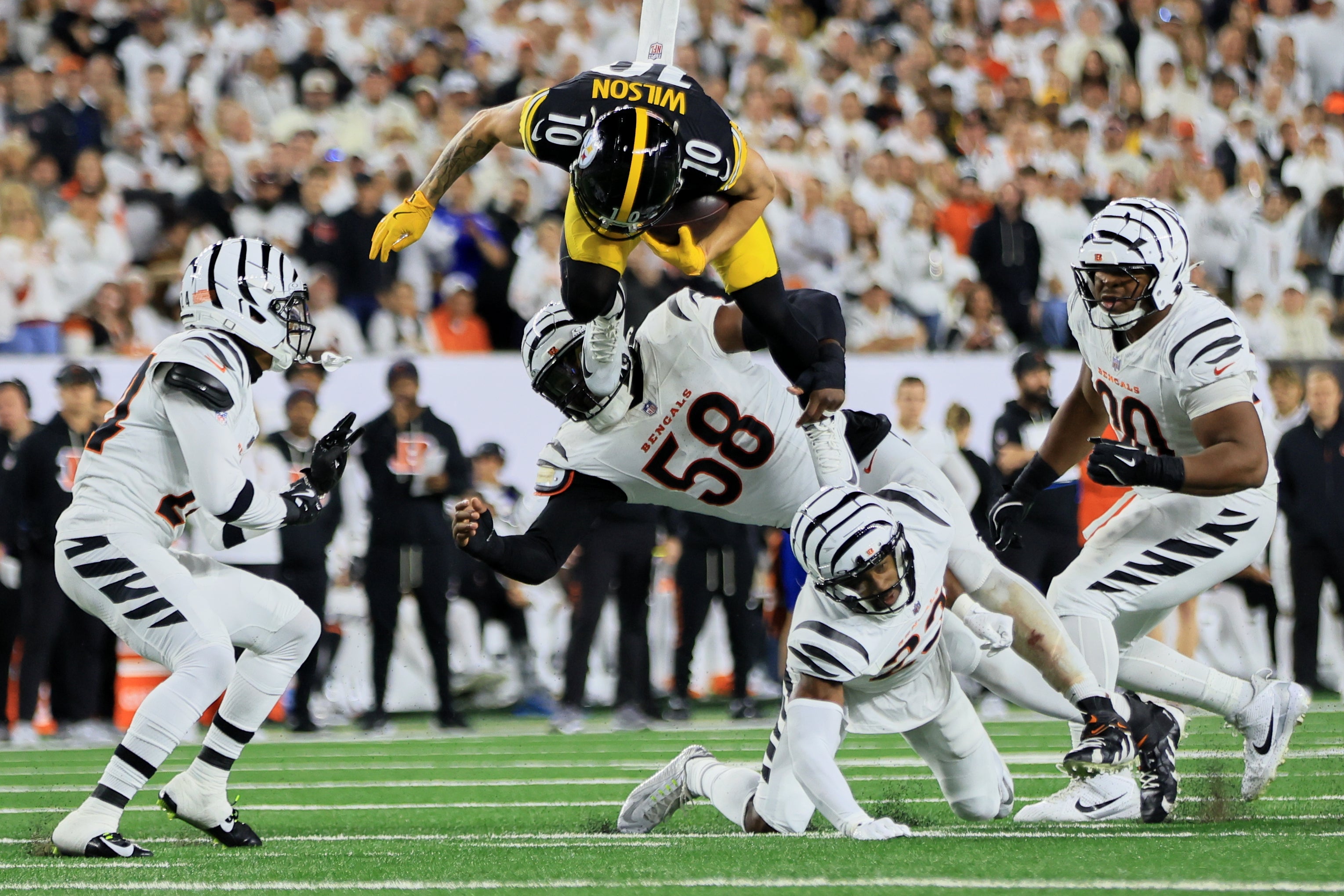 Cincinnati Bengals linebacker Shaka Heyward (50) and Cincinnati Bengals cornerback Marco Wilson (24) tackle Pittsburgh Steelers wide receiver Roman Wilson (10) in the third quarter of the NFL game between the Cincinnati Bengals and Pittsburgh Steelers at Paycor Stadium in Cincinnati on Oct. 16, 2025.