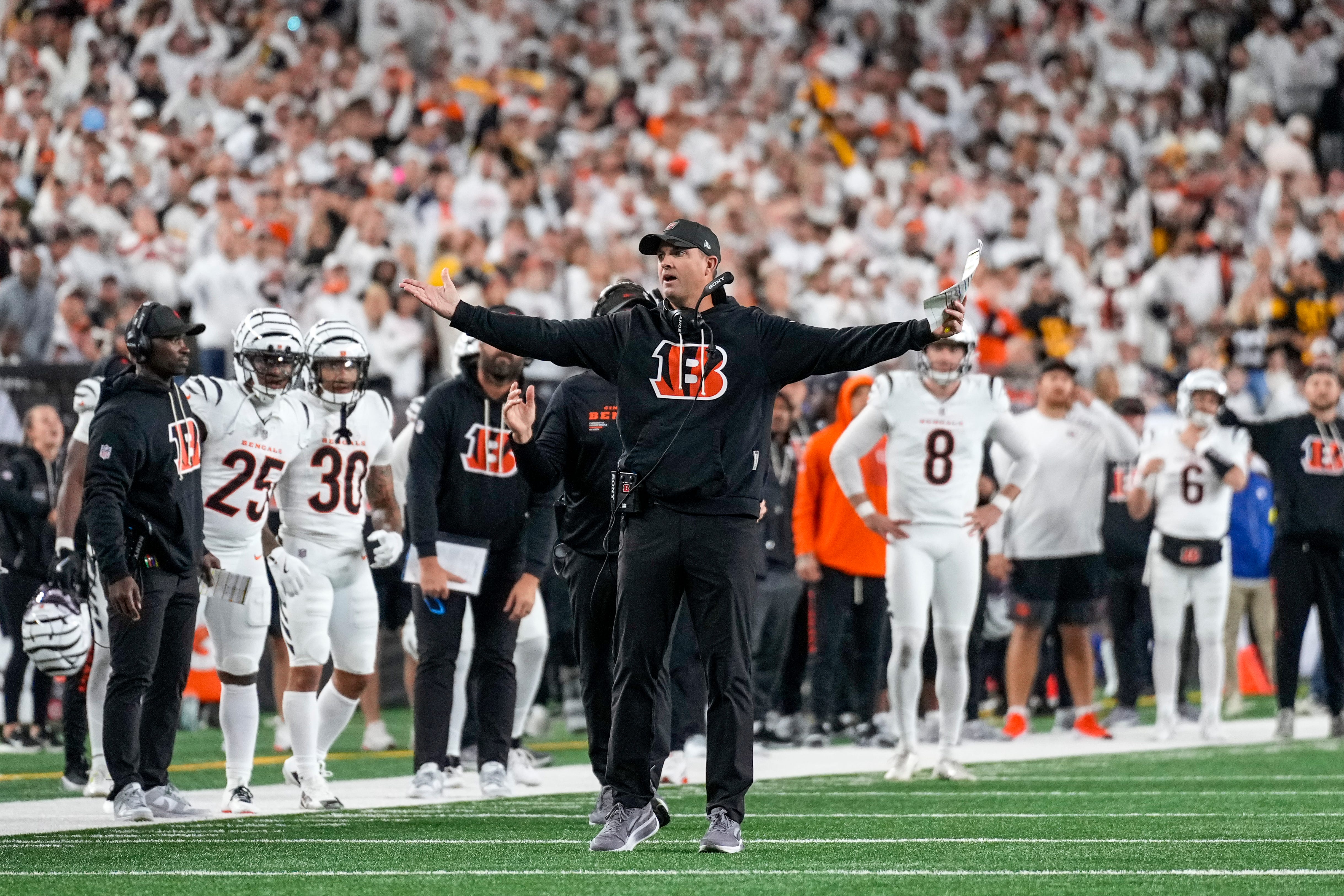 Cincinnati Bengals head coach Zac Taylor looks for a flag after a pass attempt to Tee Higgins in the fourth quarter of the NFL Week 7 game between the Cincinnati Bengals and the Pittsburgh Steelers at Paycor Stadium in downtown Cincinnati on Thursday, Oct. 16, 2025. The Bengals won, 33-31.