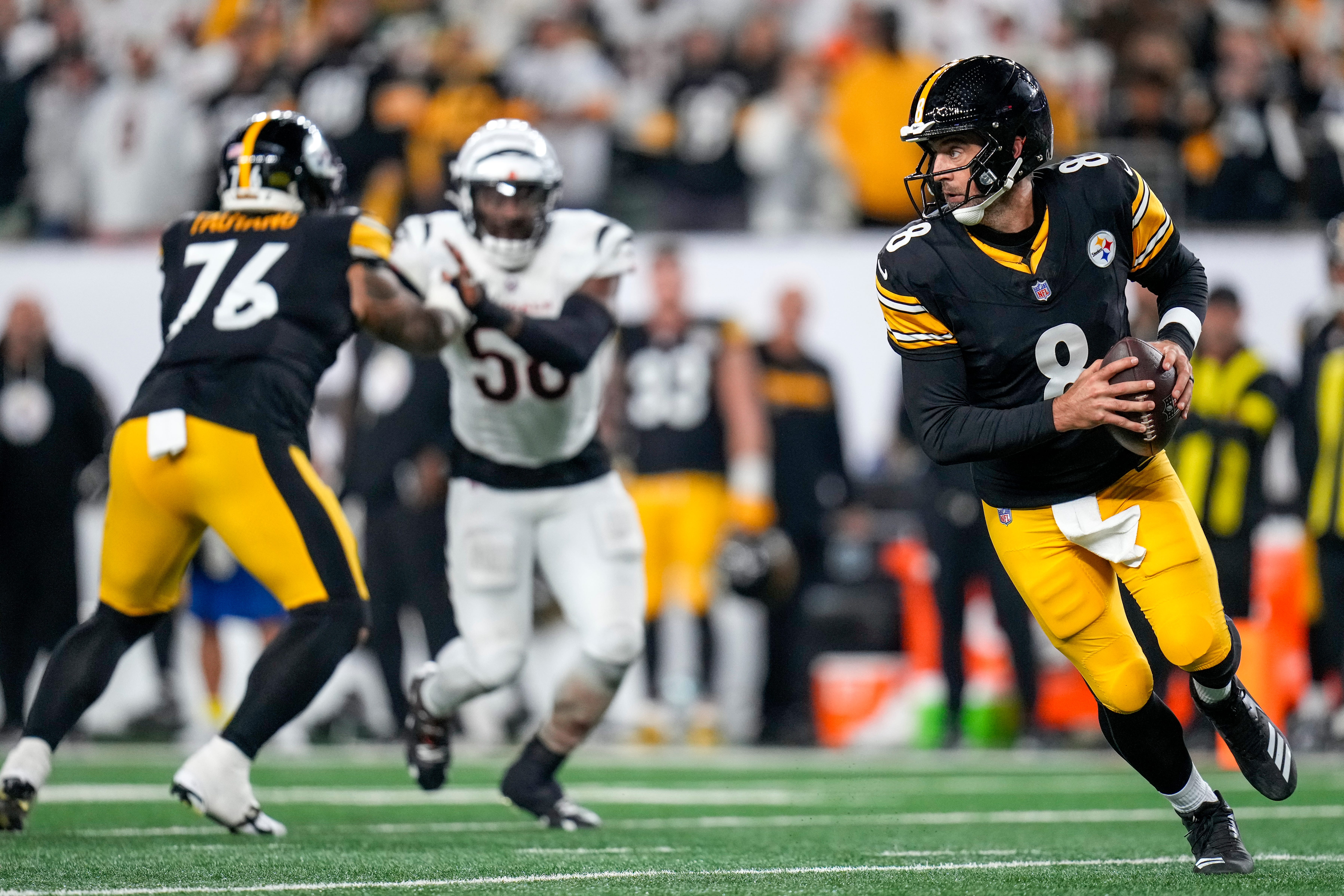 Pittsburgh Steelers quarterback Aaron Rodgers (8) rolls out of the pocket before attempting a final deep pass to end the fourth quarter of the NFL Week 7 game between the Cincinnati Bengals and the Pittsburgh Steelers at Paycor Stadium in downtown Cincinnati on Thursday, Oct. 16, 2025. The Bengals won, 33-3