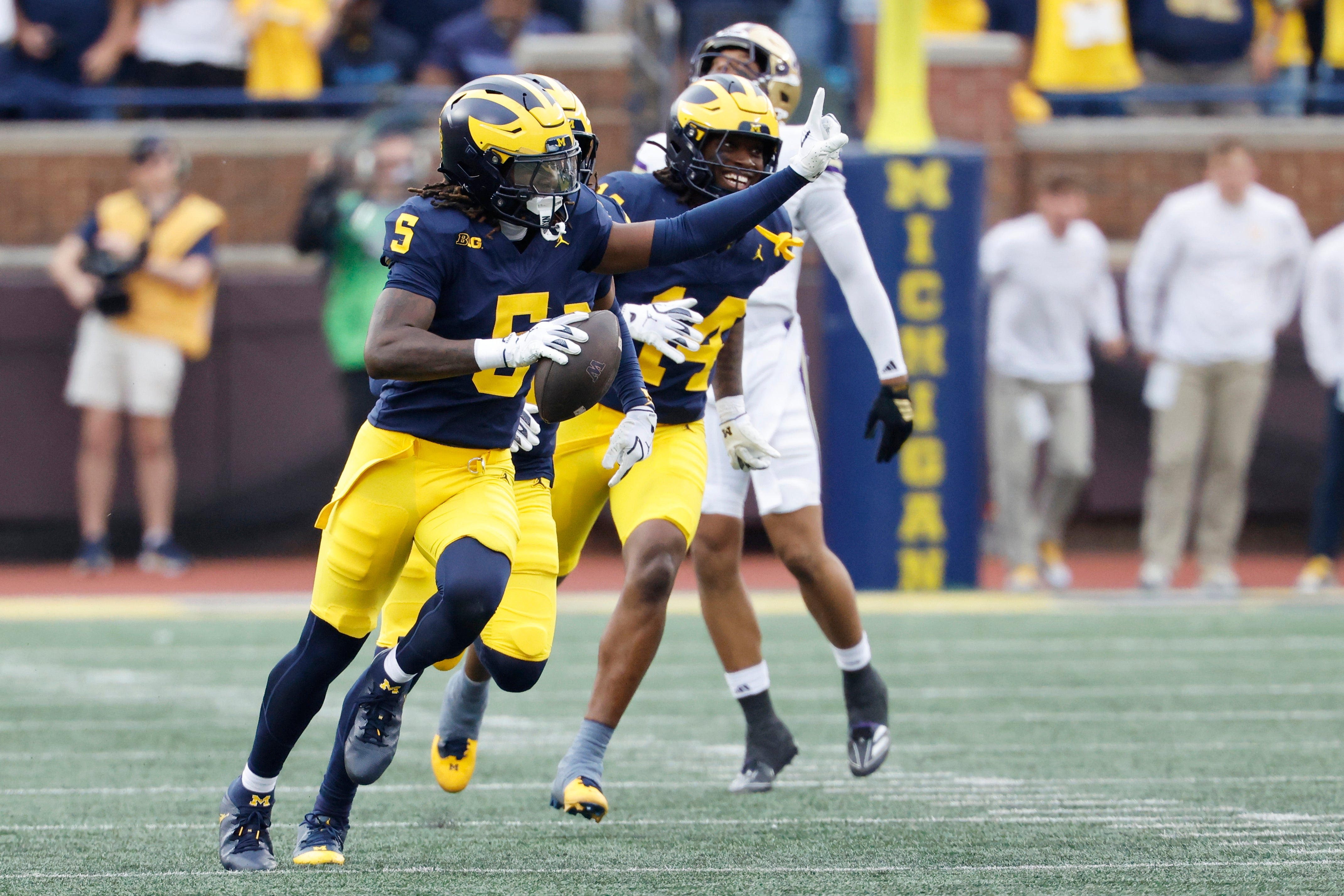 Oct 18, 2025; Ann Arbor, Michigan, USA; Michigan Wolverines defensive back Jacob Oden (5) celebrates after he makes an interception in the second half against the Washington Huskies at Michigan Stadium.