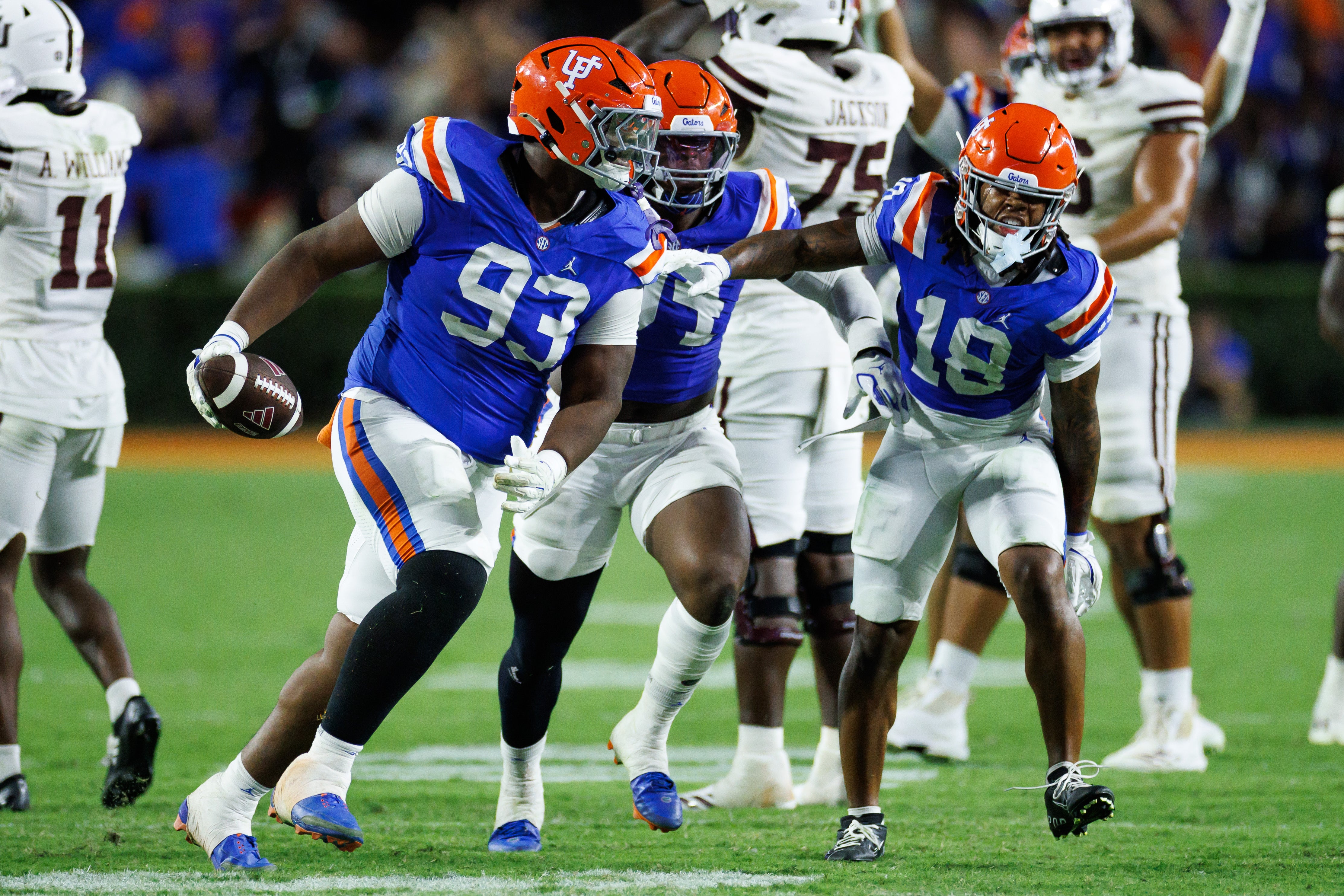 Oct 18, 2025; Gainesville, Florida, USA; Florida Gators defensive tackle Michai Boireau (93) celebrates with safety Bryce Thornton (18) after an interception during the second half at Ben Hill Griffin Stadium.