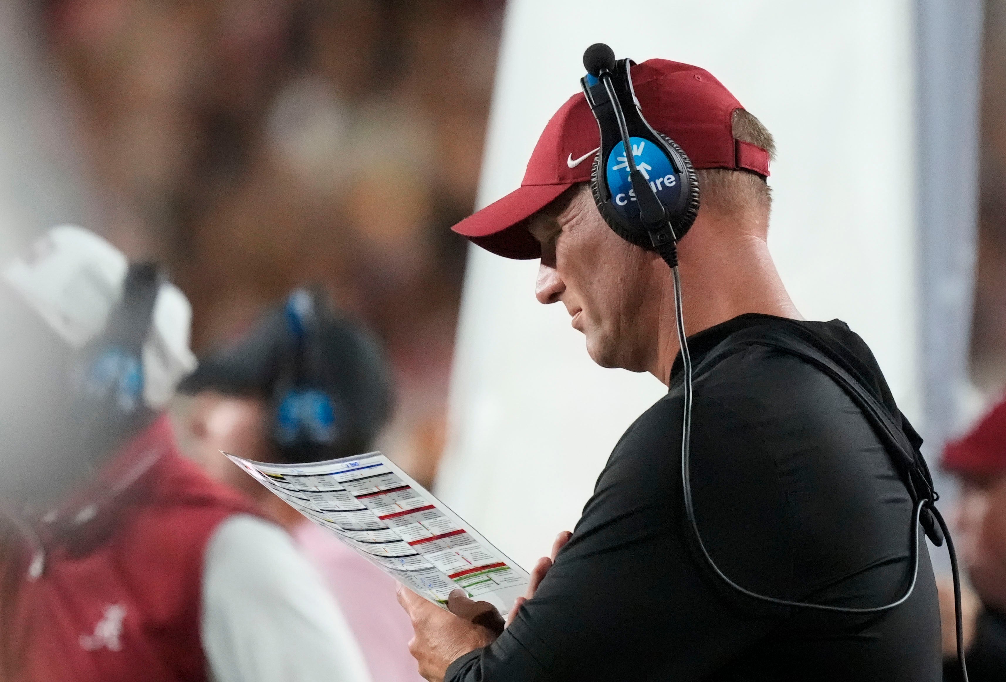 Oct 18, 2025; Tuscaloosa, Alabama, USA; Alabama head coach Kalen DeBoer studies his play sheet during the second quarter against the Tennessee Volunteers at Saban Field at Bryant-Denny Stadium. Mandatory Credit