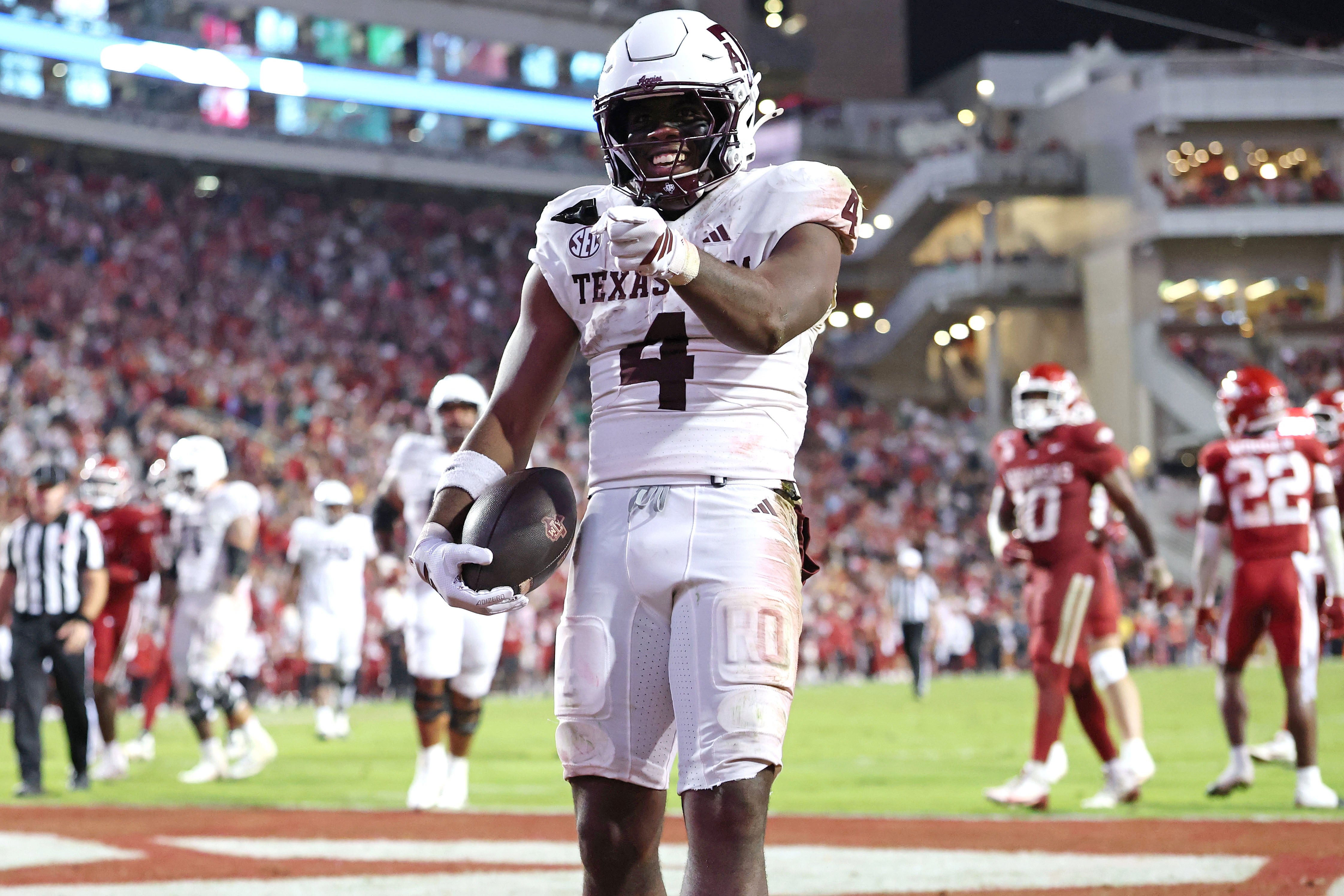 Oct 18, 2025; Fayetteville, Arkansas, USA; Texas A&M Aggies running back Rueben Owens II (4) celebrates after rushing for a touchdown in the fourth quarter against the Arkansas Razorbacks at Donald W. Reynolds Razorback Stadium.