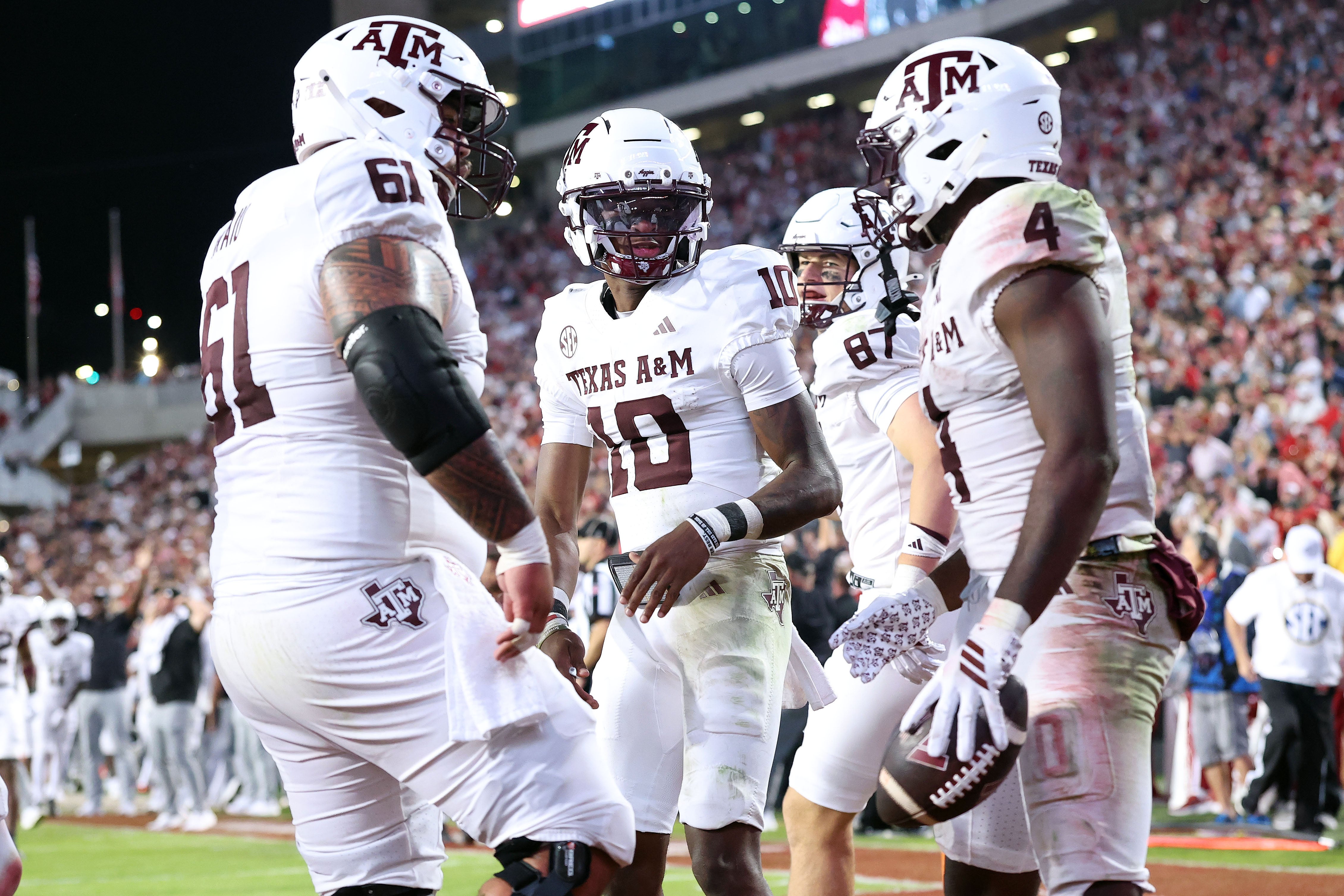 Oct 18, 2025; Fayetteville, Arkansas, USA; Texas A&M Aggies quarterback Marcel Reed (10) celebrates with running back Rueben Owens II (4) after Owner rushed for a touchdown in the fourth quarter against the Arkansas Razorbacks at Donald W. Reynolds Razorback Stadium.