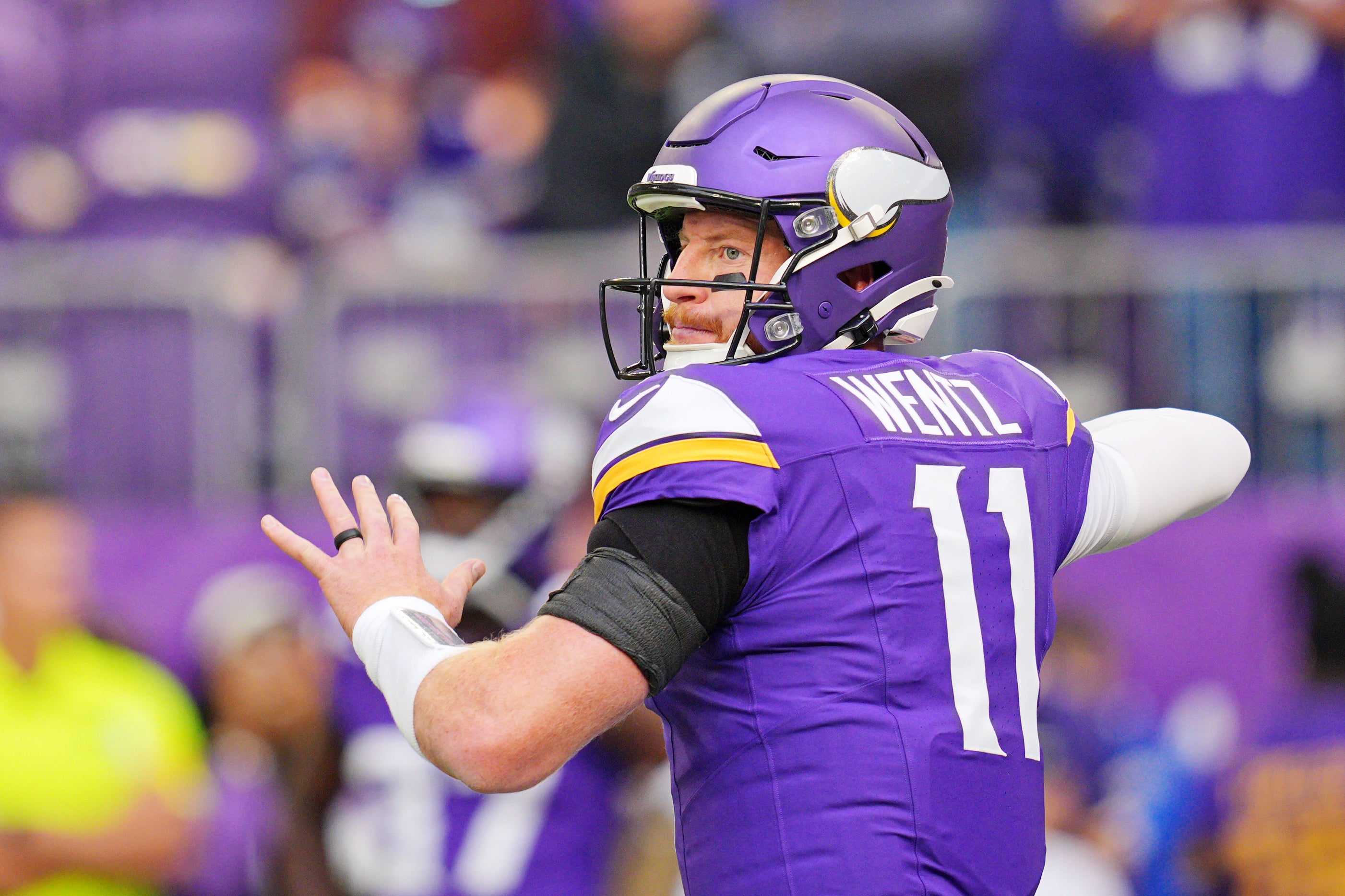 Oct 19, 2025; Minneapolis, Minnesota, USA; Minnesota Vikings quarterback Carson Wentz (11) warms up before the game against the Philadelphia Eagles at U.S. Bank Stadium.