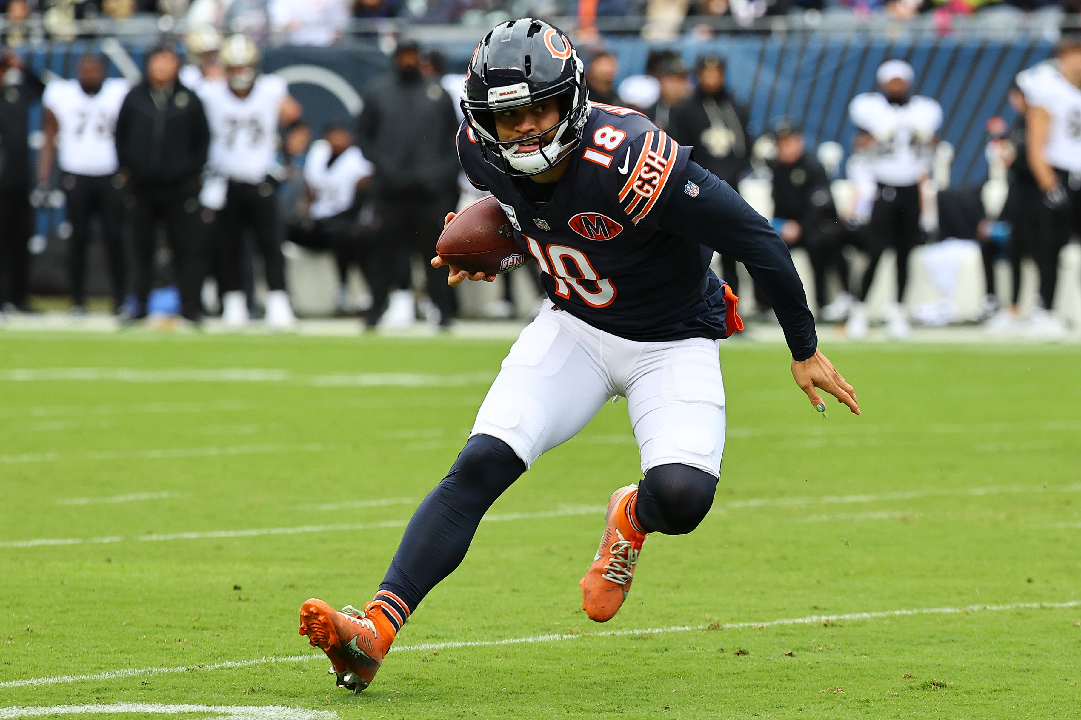 Oct 19, 2025; Chicago, Illinois, USA; Chicago Bears quarterback Caleb Williams (18) rushes the ball against the New Orleans Saints during the first quarter at Soldier Field.