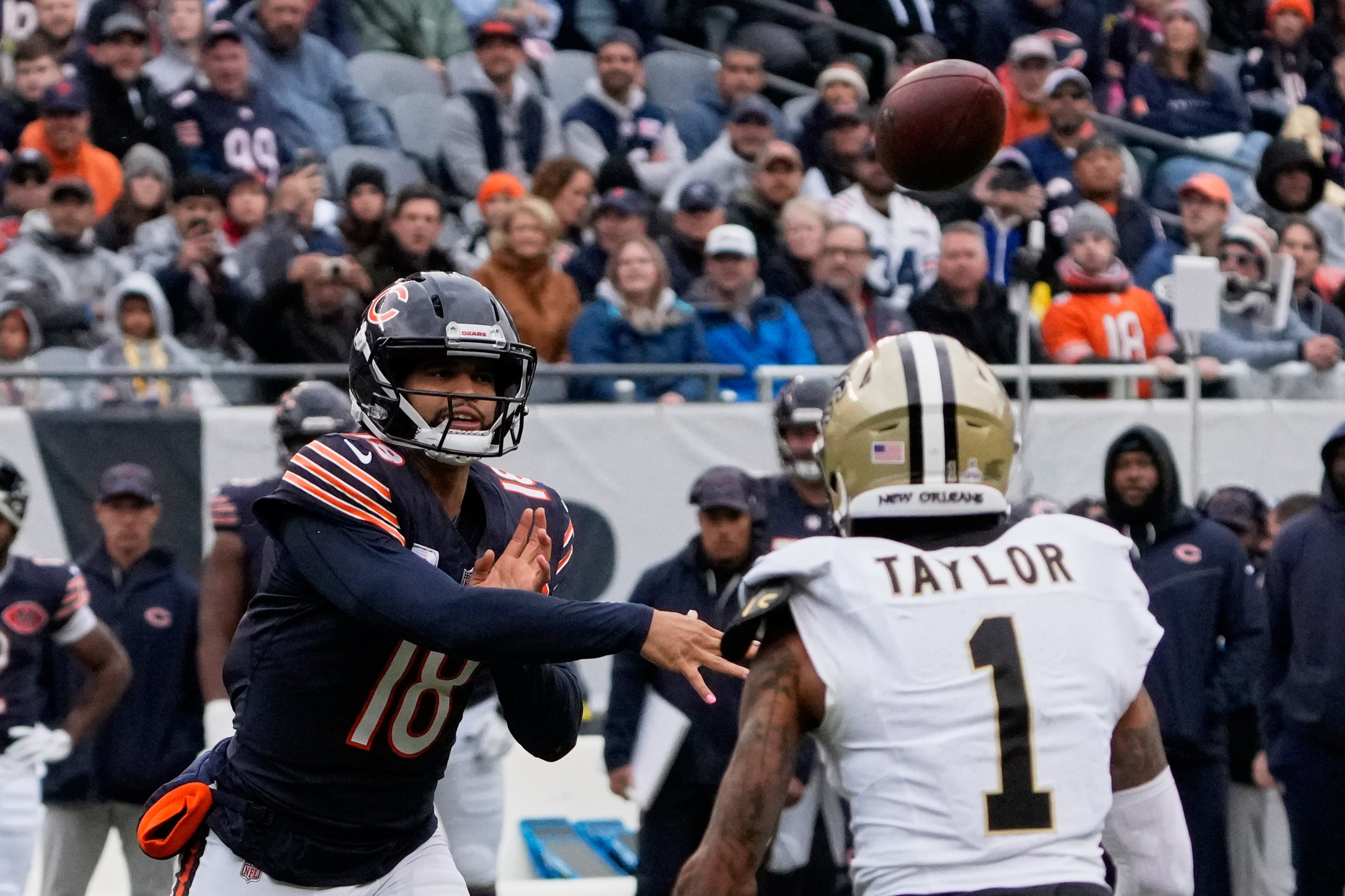 Oct 19, 2025; Chicago, Illinois, USA; Chicago Bears quarterback Caleb Williams (18) throws a pass against New Orleans Saints cornerback Alontae Taylor (1) during the first half at Soldier Field.