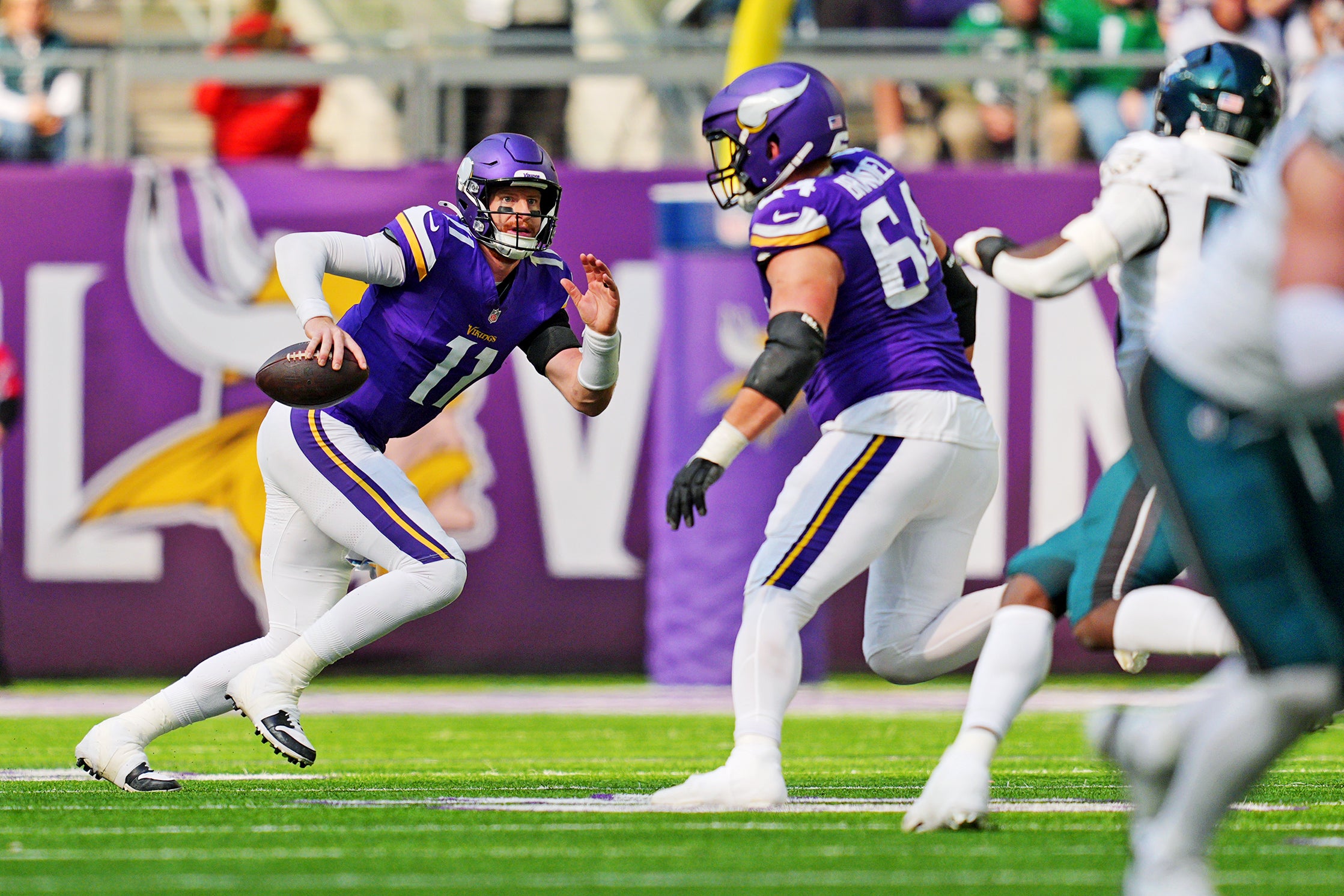 Oct 19, 2025; Minneapolis, Minnesota, USA; Minnesota Vikings quarterback Carson Wentz (11) runs the ball during the second half against the Philadelphia Eagles at U.S. Bank Stadium.