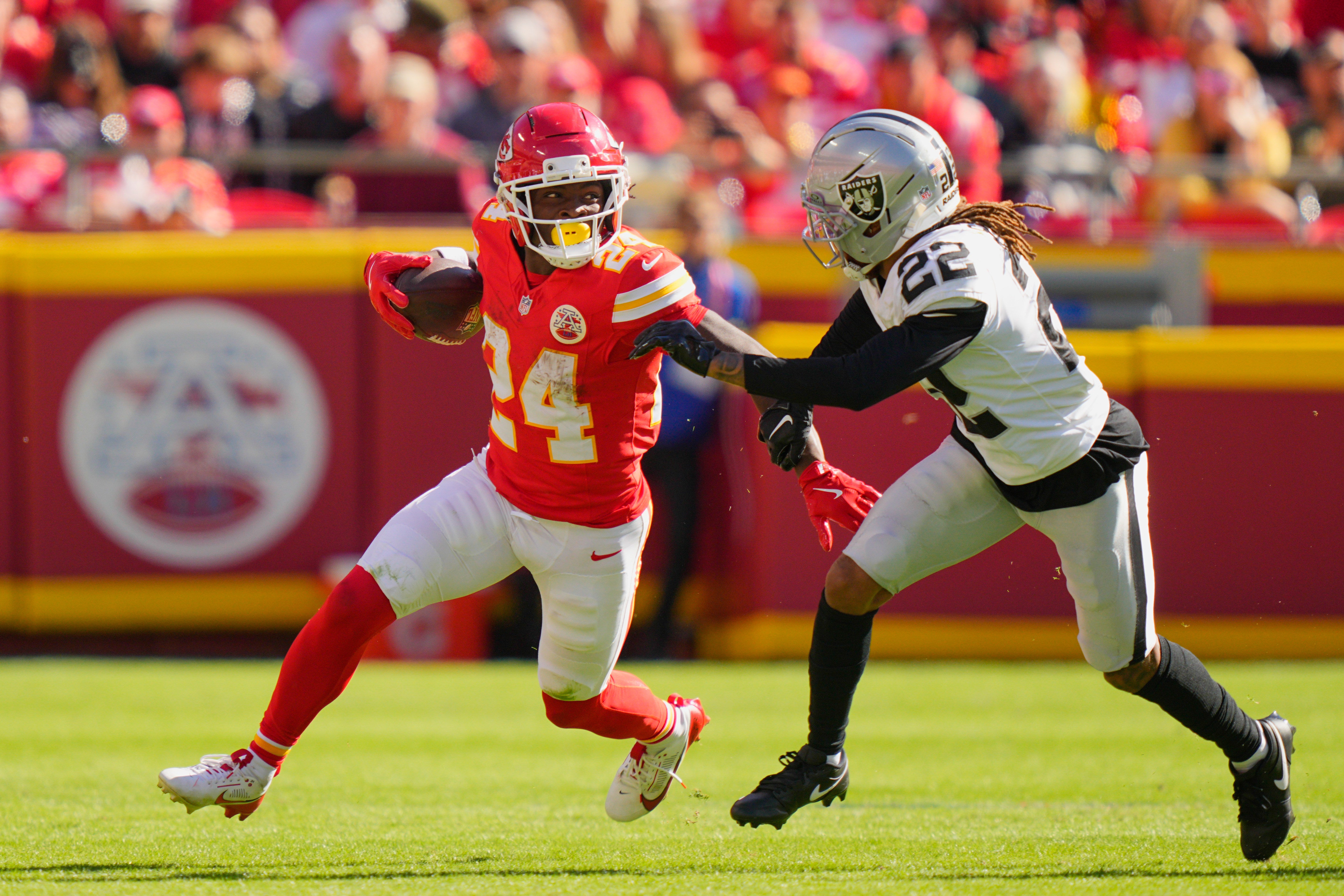 Kansas City Chiefs running back Brashard Smith (24) carries the ball defended by Las Vegas Raiders cornerback Eric Stokes (22)