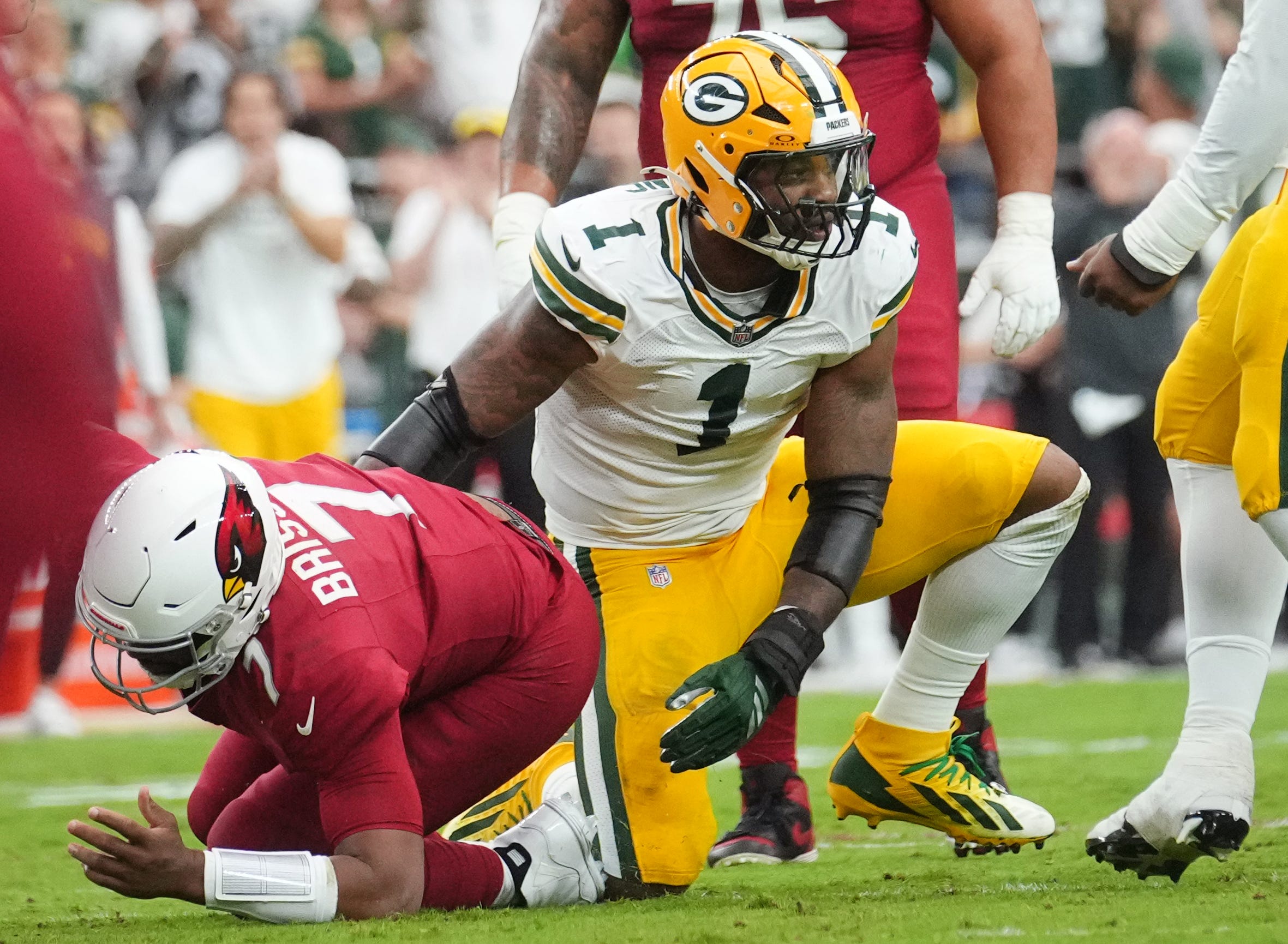 Arizona Cardinals quarterback Jacoby Brissett (7) is sacked by Green Bay Packers defensive lineman Micah Parsons (1) at State Farm Stadium in Glendale on Oct. 19, 2025.