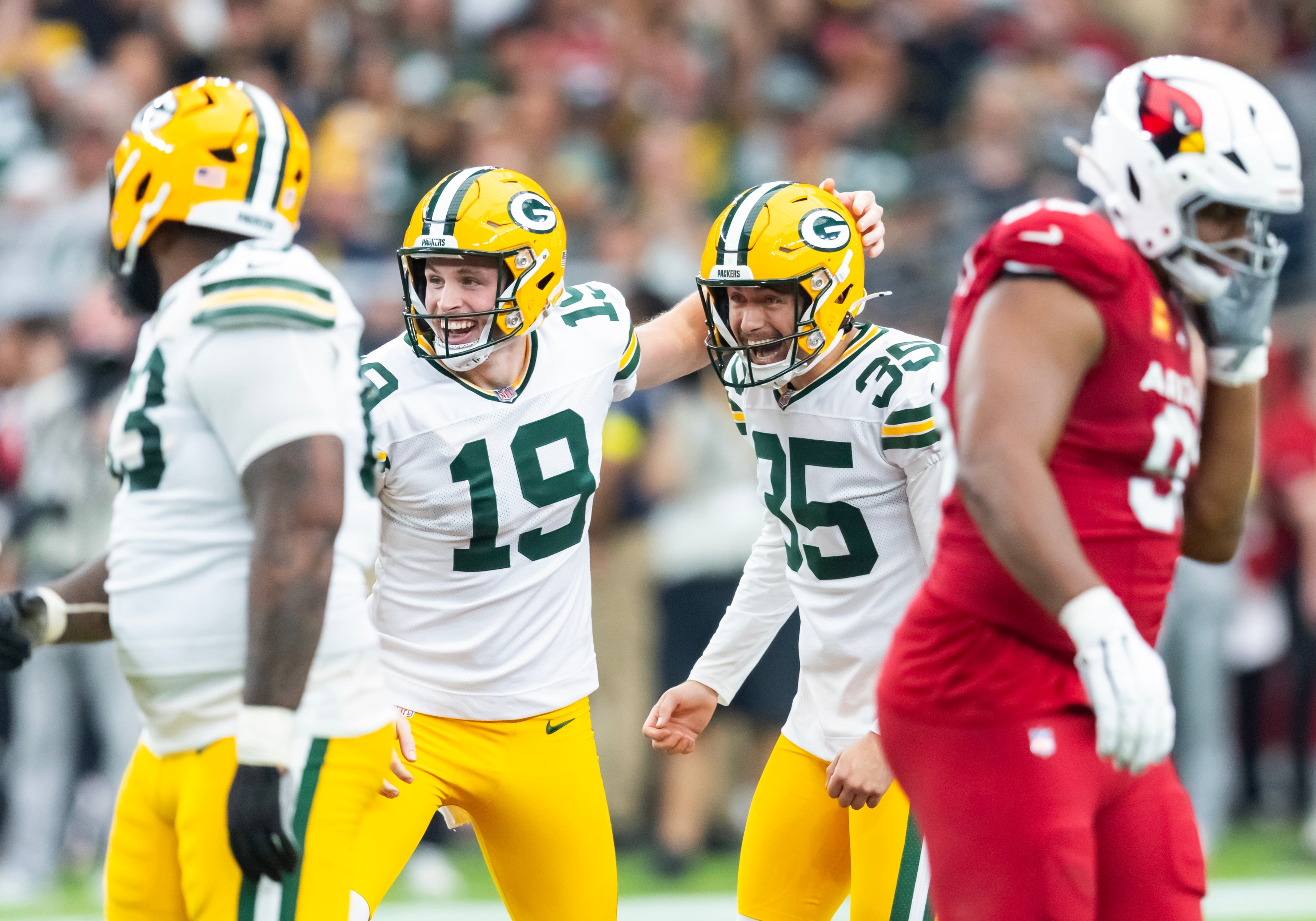 Oct 19, 2025; Glendale, Arizona, USA; Green Bay Packers kicker Lucas Havrisik (35) celebrates a field goal with punter Daniel Whelan (19) against the Arizona Cardinals in the first half at State Farm Stadium.