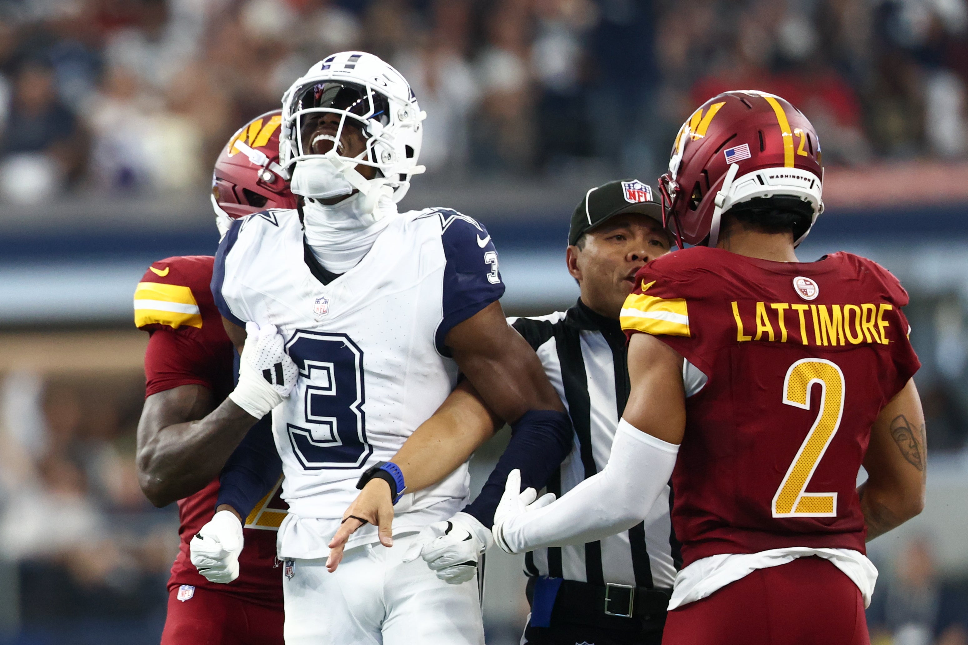 Dallas Cowboys wide receiver George Pickens (3) celebrates after a play as Washington Commanders safety Quan Martin (20) and cornerback Marshon Lattimore (2) look on during the second quarter of the game at AT&T Stadium.