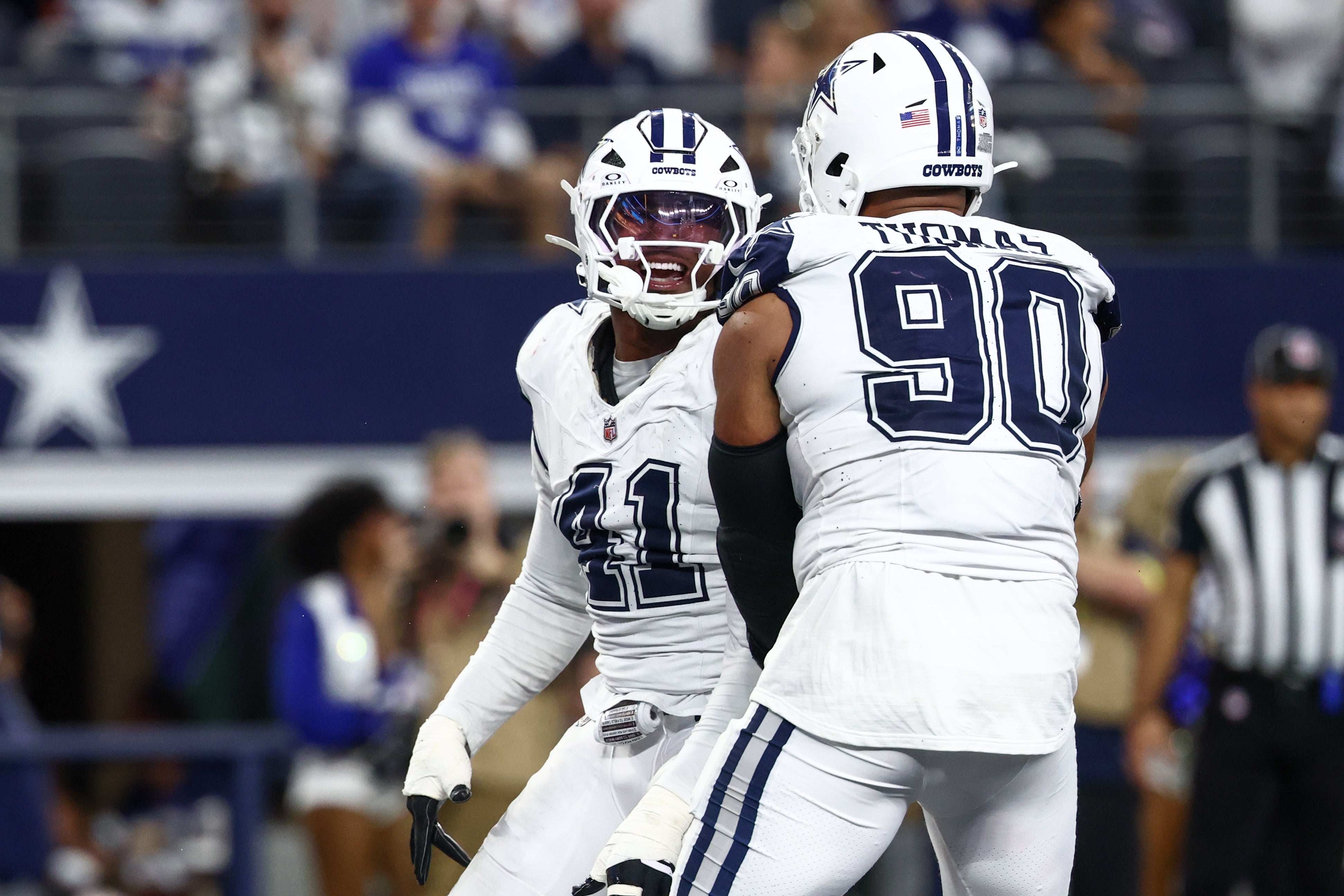 Oct 19, 2025; Arlington, Texas, USA; Dallas Cowboys defensive end Donovan Ezeiruaku (41) and defensive end Solomon Thomas (90) celebrate after a sack against the Washington Commanders during the fourth quarter of the game at AT&T Stadium.