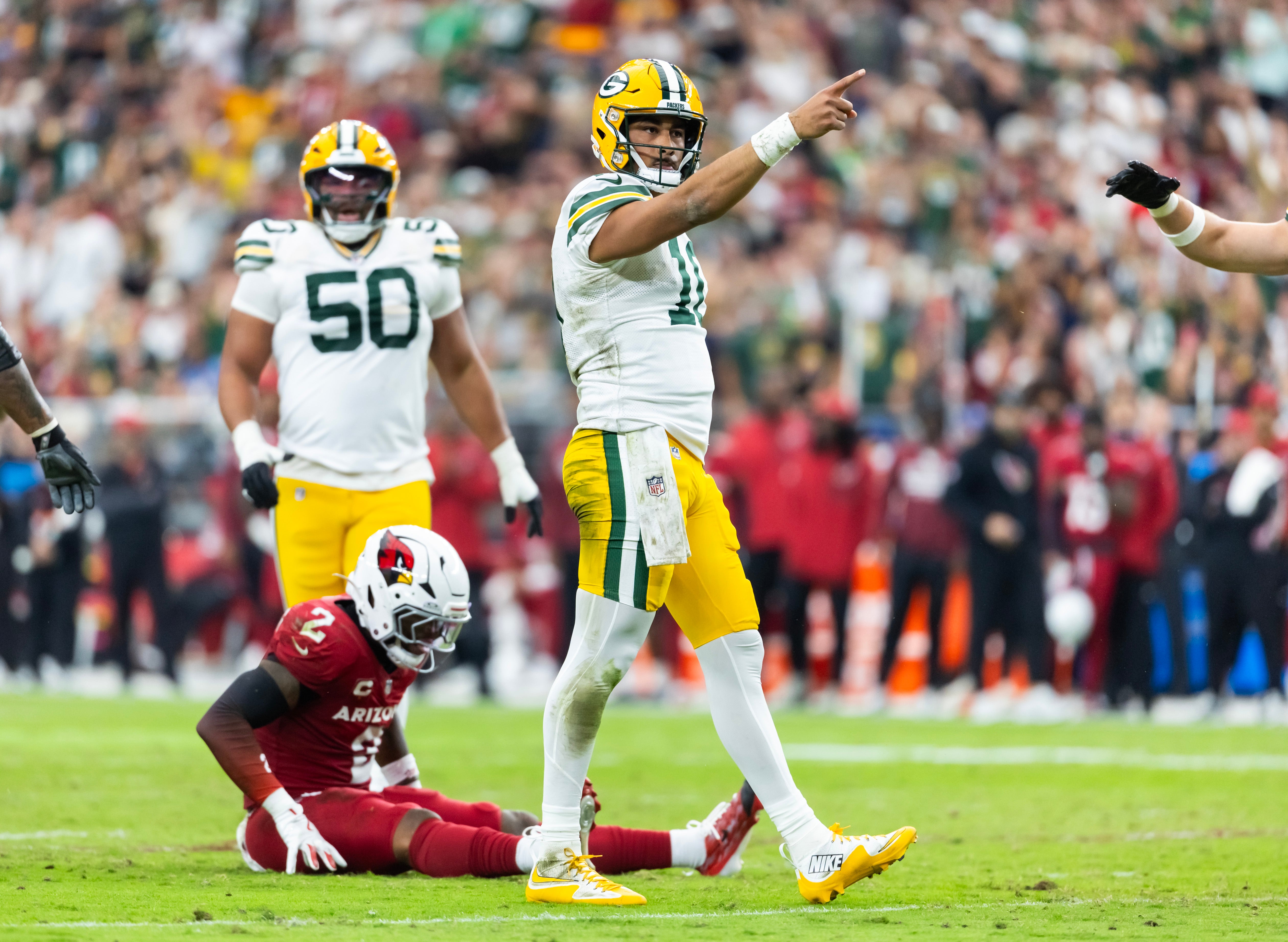 Oct 19, 2025; Glendale, Arizona, USA; Green Bay Packers quarterback Jordan Love (10) celebrates a first down against the Arizona Cardinals in the second half at State Farm Stadium.