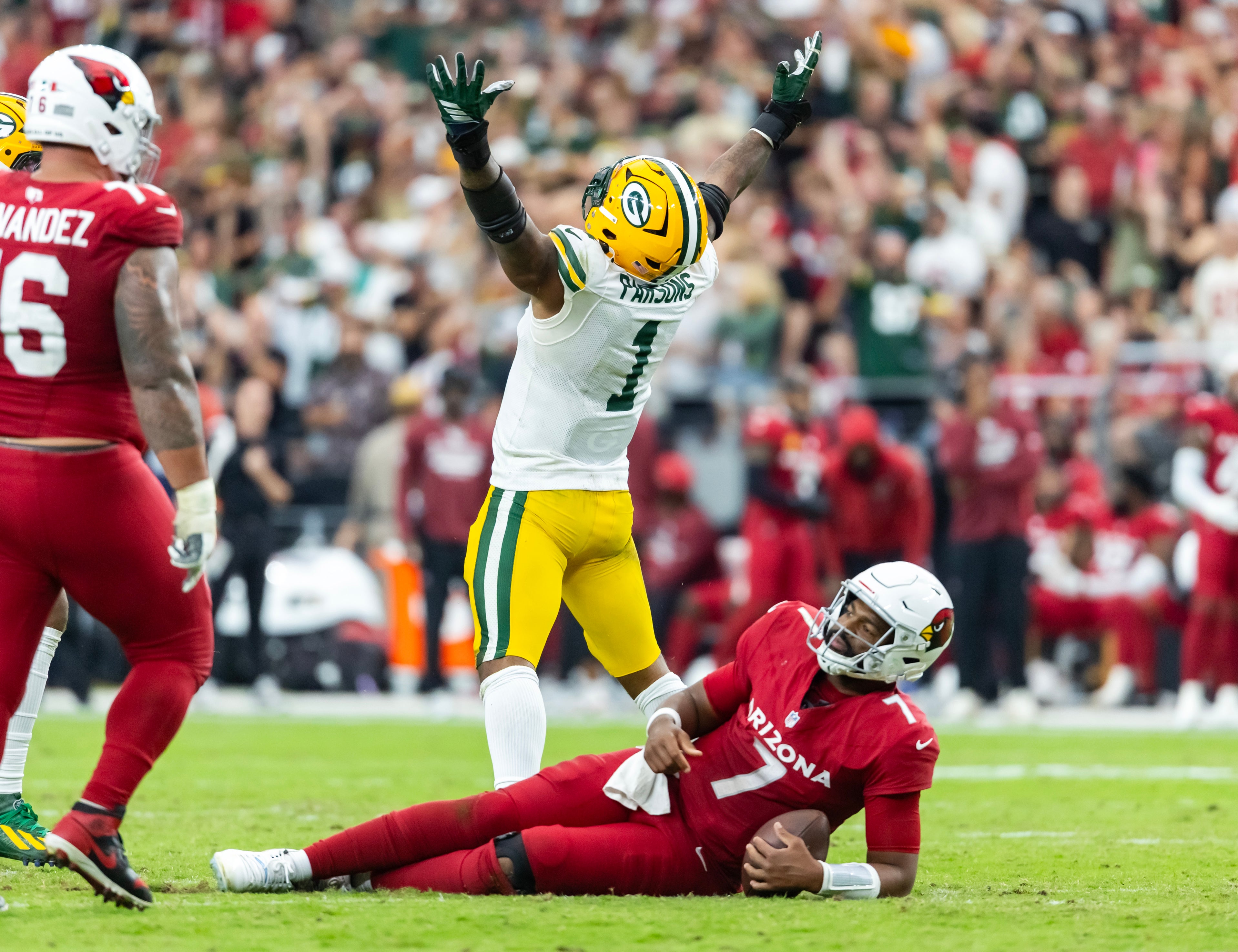 Oct 19, 2025; Glendale, Arizona, USA; Arizona Cardinals quarterback Jacoby Brissett (7) is sacked by Green Bay Packers defensive lineman Micah Parsons (1) in the second half at State Farm Stadium.