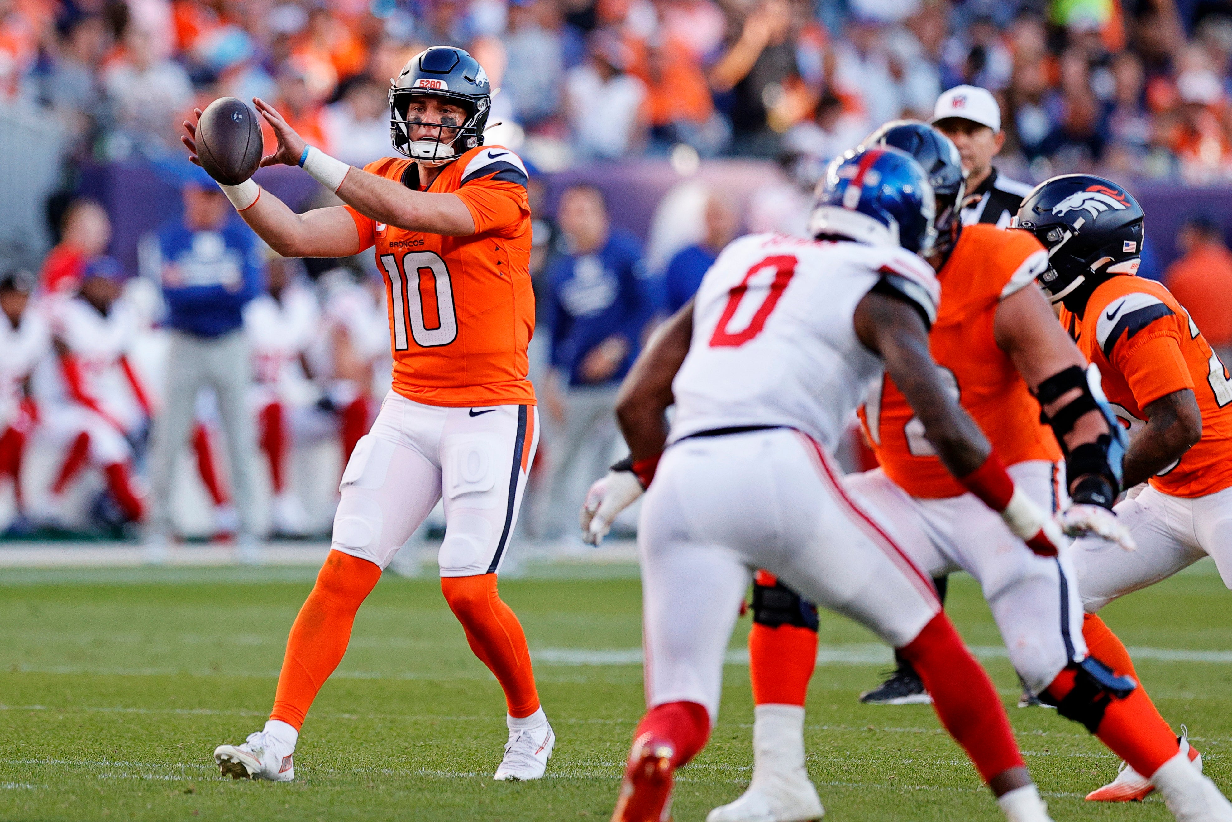 Oct 19, 2025; Denver, Colorado, USA; Denver Broncos quarterback Bo Nix (10) throws a pass against the New York Giants during the second half at Empower Field at Mile High.
