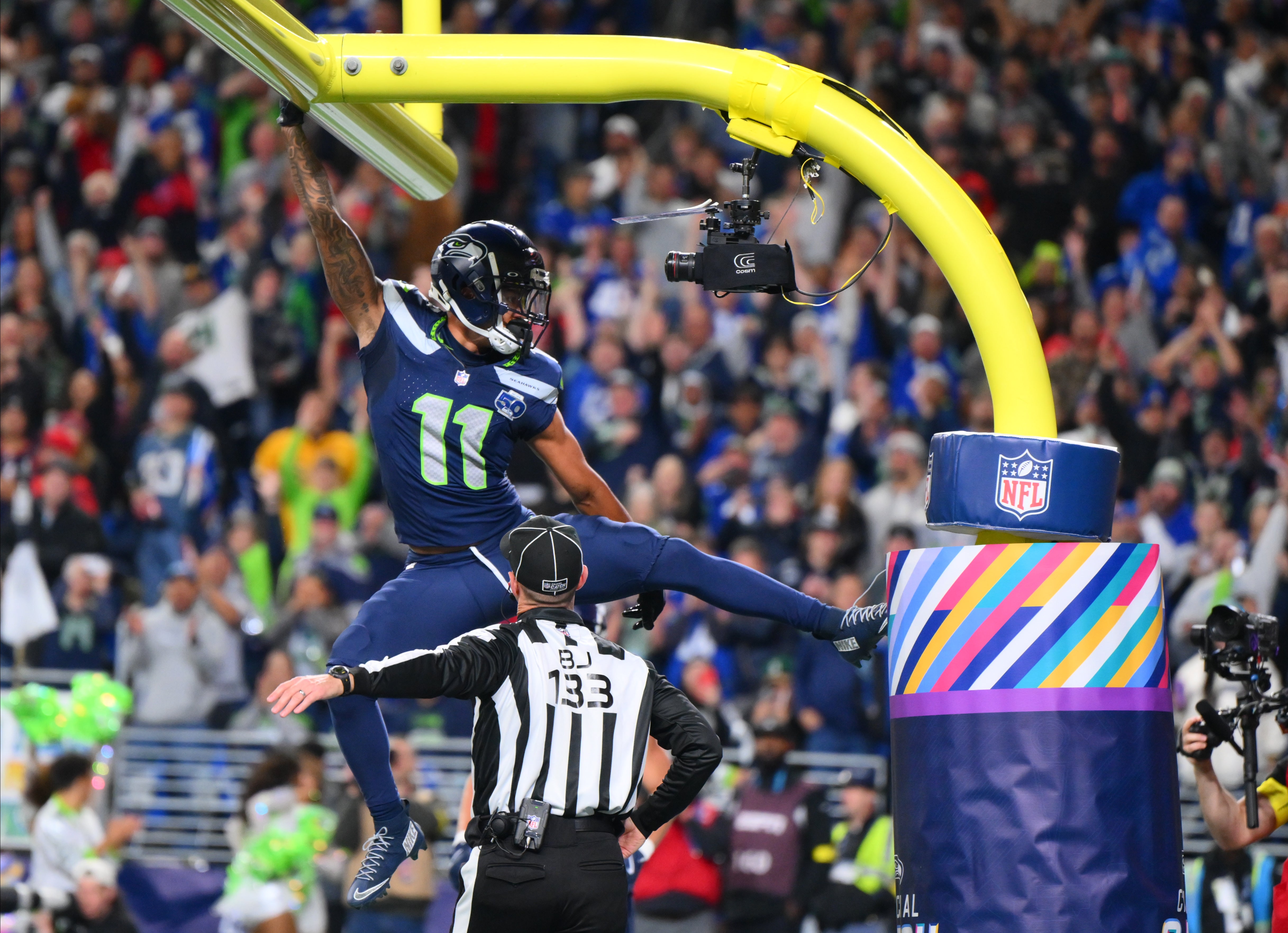 Oct 20, 2025; Seattle, Washington, USA; Seattle Seahawks wide receiver Jaxon Smith-Njigba (11) celebrates on the goal post after a touchdown during the first quarter against the Houston Texans at Lumen Field.